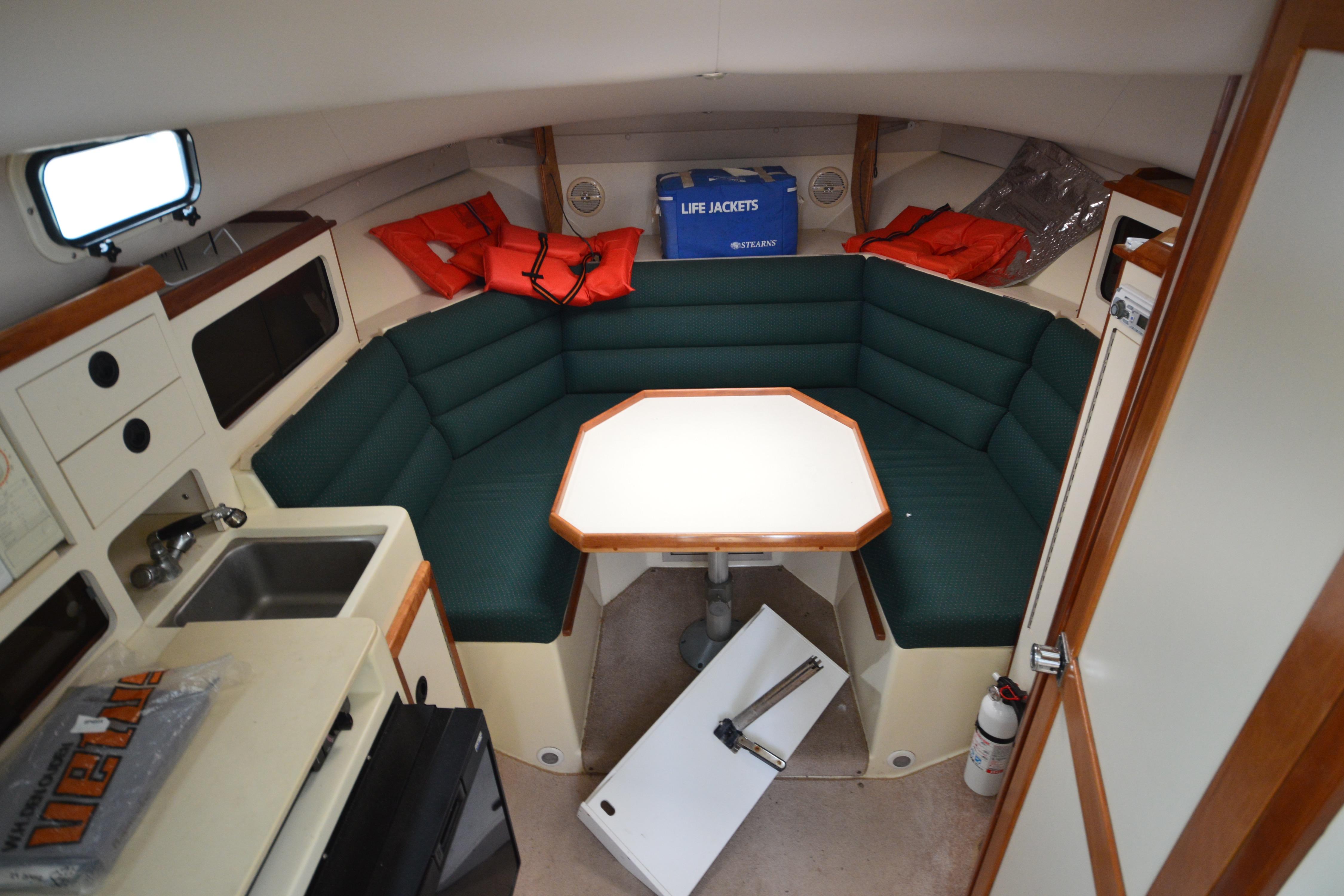 Interior of 2001 Albin 28 Tournament Express with seating, table, and kitchenette.