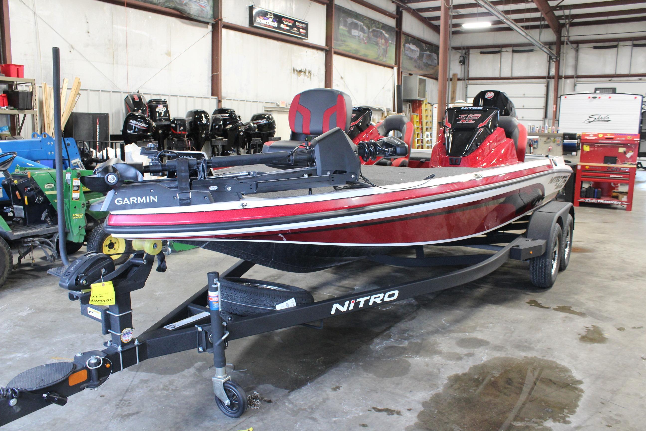 2026 Nitro Z19 XL Pro boat in a garage, featuring Garmin equipment.