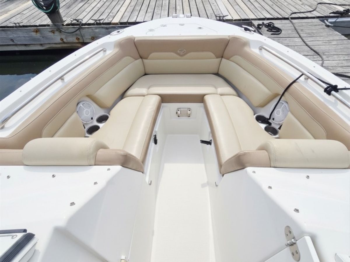 The 2020 Sailfish 245 DC features beige upholstery and speakers in the bow area.