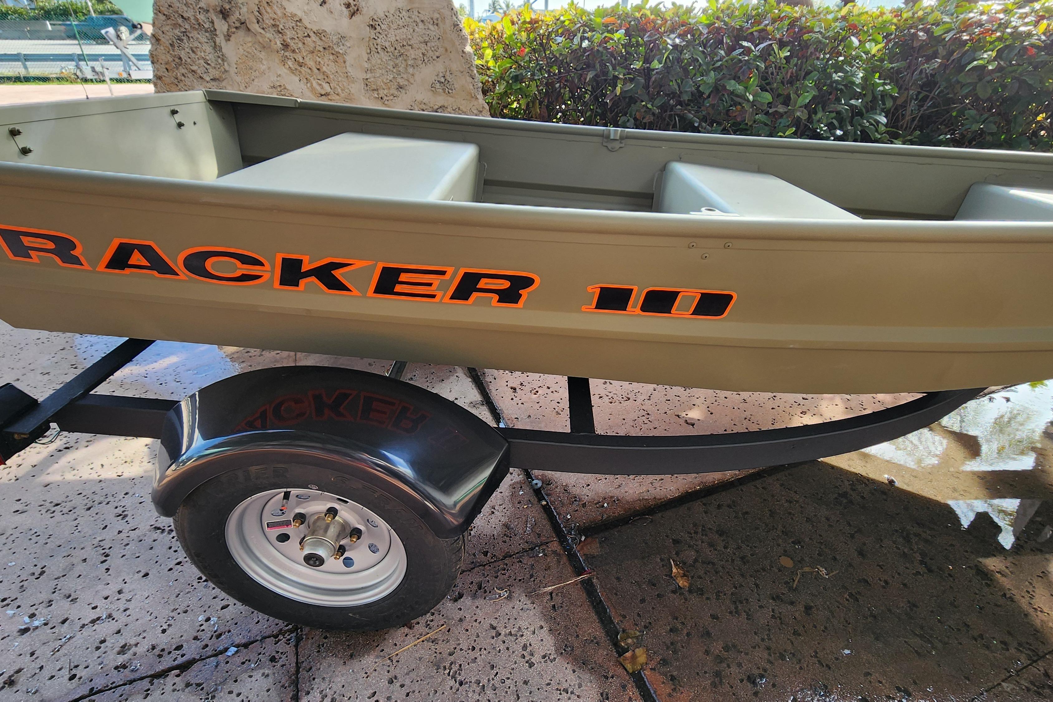 2026 Tracker Grizzly 10 Jon boat on trailer, showcasing bold orange lettering.