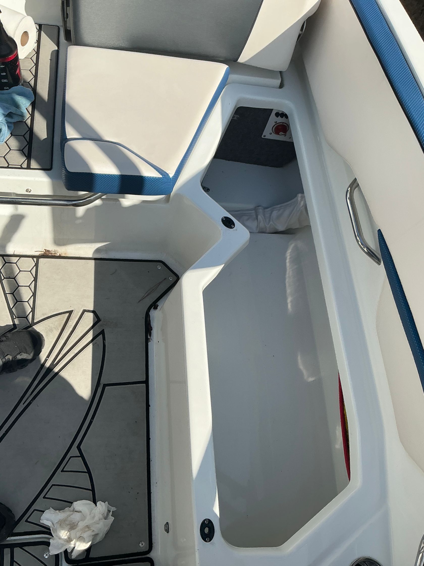 Interior of a 2021 Scarab 215 ID boat with storage compartment.