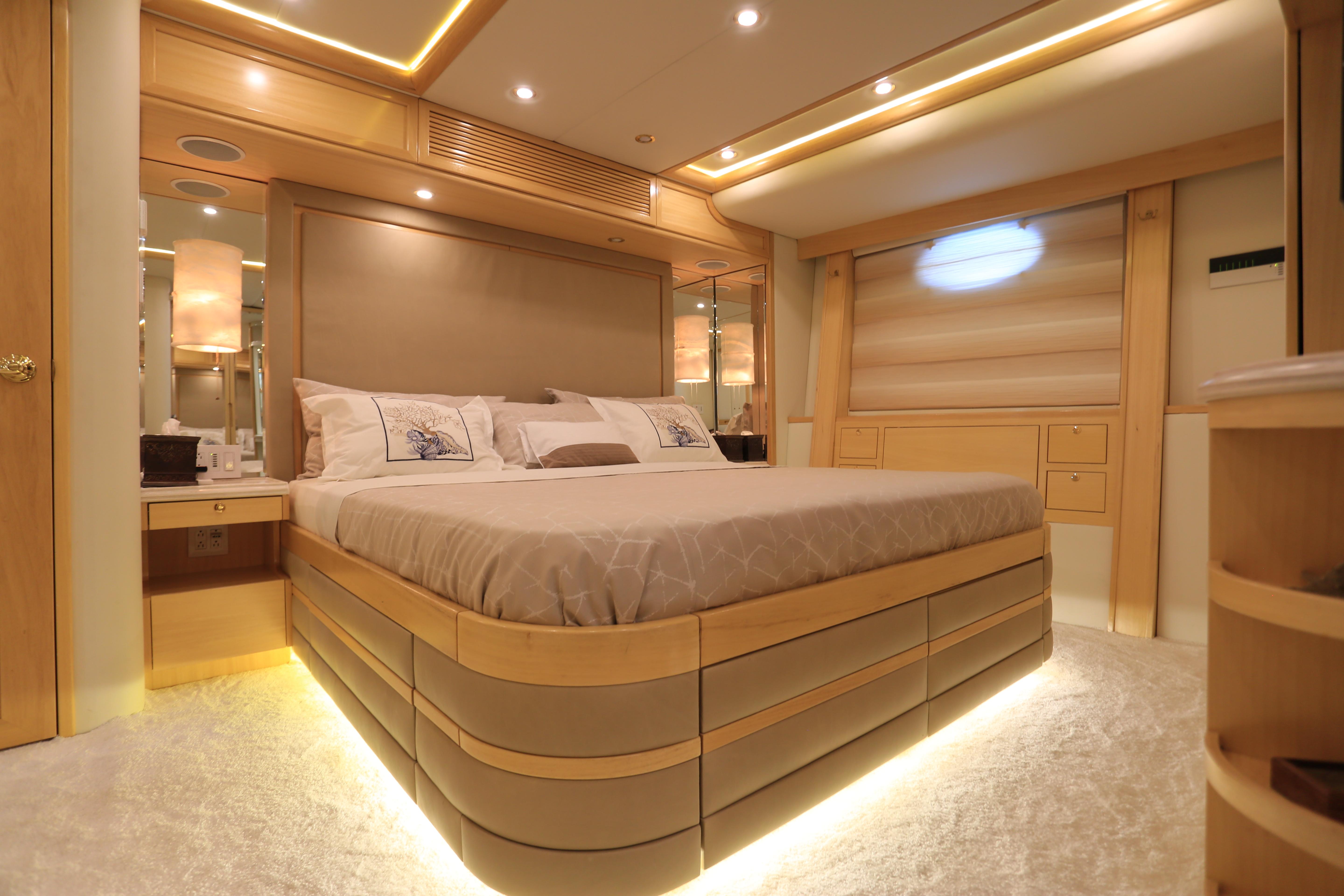 Luxurious bedroom interior in a 2004 Westport Custom yacht, featuring elegant lighting and modern design.