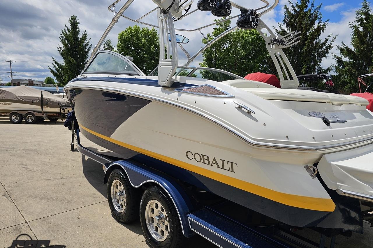 2010 Cobalt 232 WSS boat on trailer, featuring sleek design and vibrant colors.