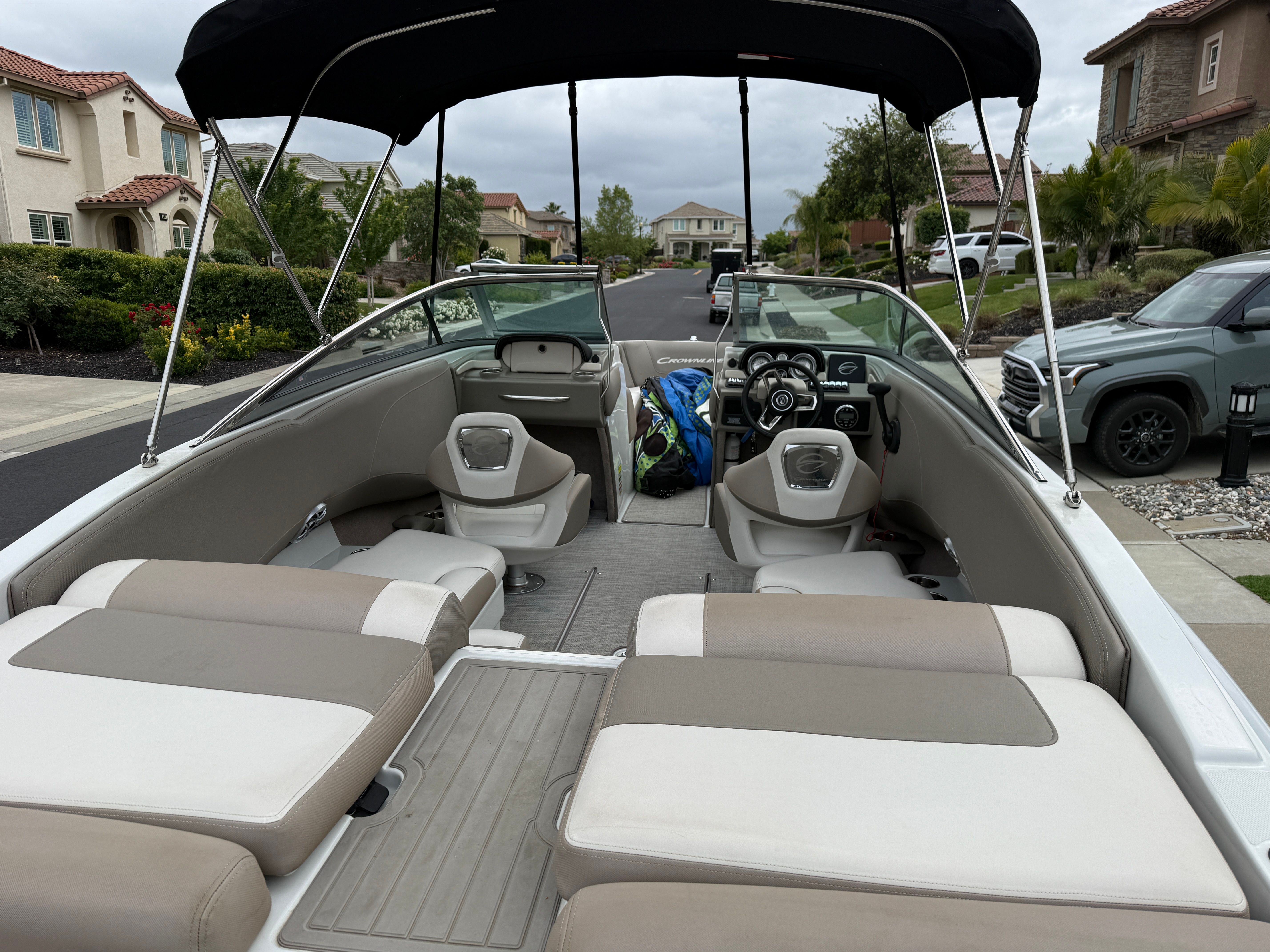 Interior of a 2019 Crownline 235 SS boat parked in a residential area.