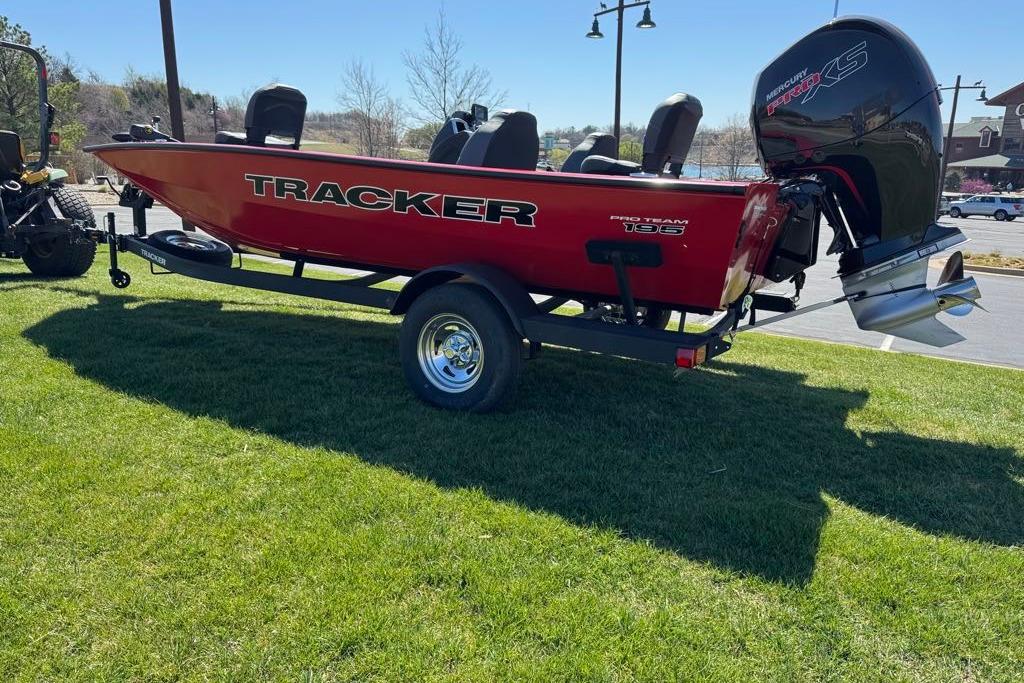 2026 Tracker Pro Team 195 boat on trailer, parked on grass.