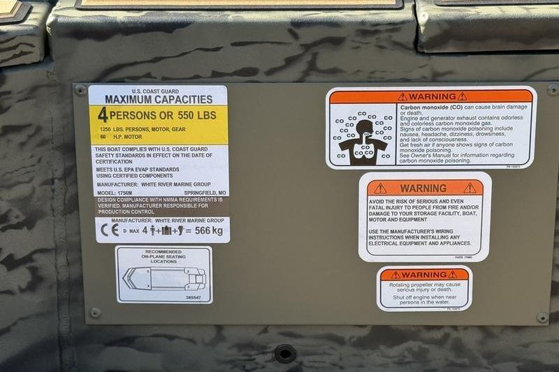 2026 Tracker Grizzly 1756 T Marsh capacity and safety warning labels on boat interior.