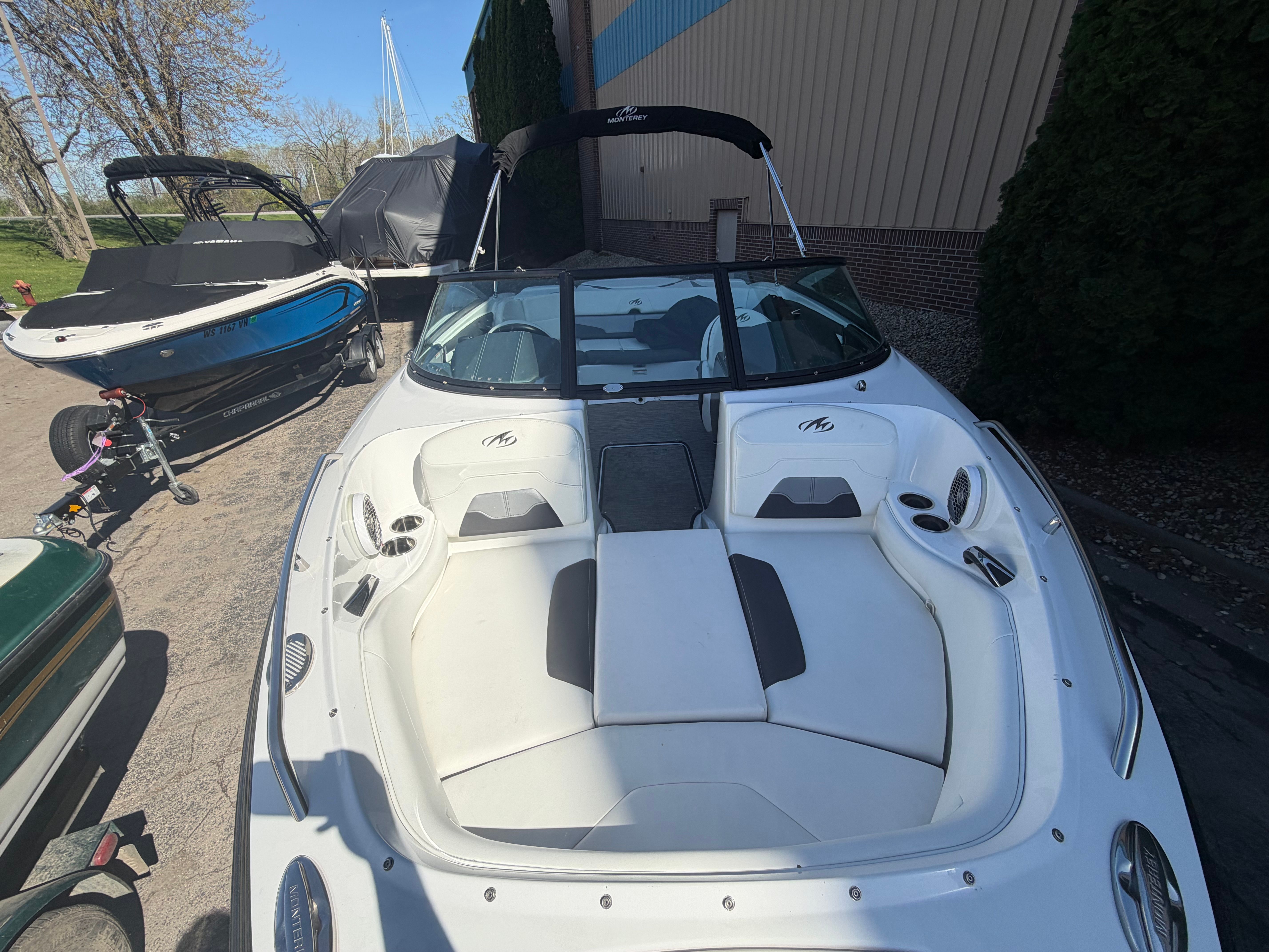 A white 2019 Monterey 224FS boat on land. It features an open cabin with seating.