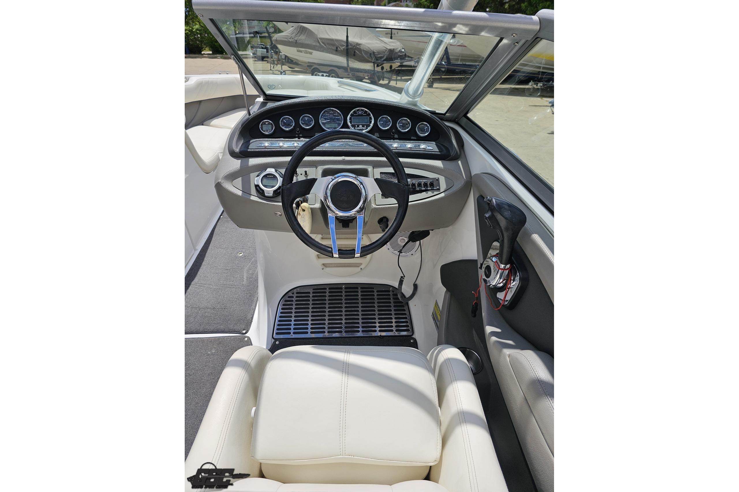 Cockpit of 2010 Cobalt 232 WSS boat with steering wheel and dashboard controls.