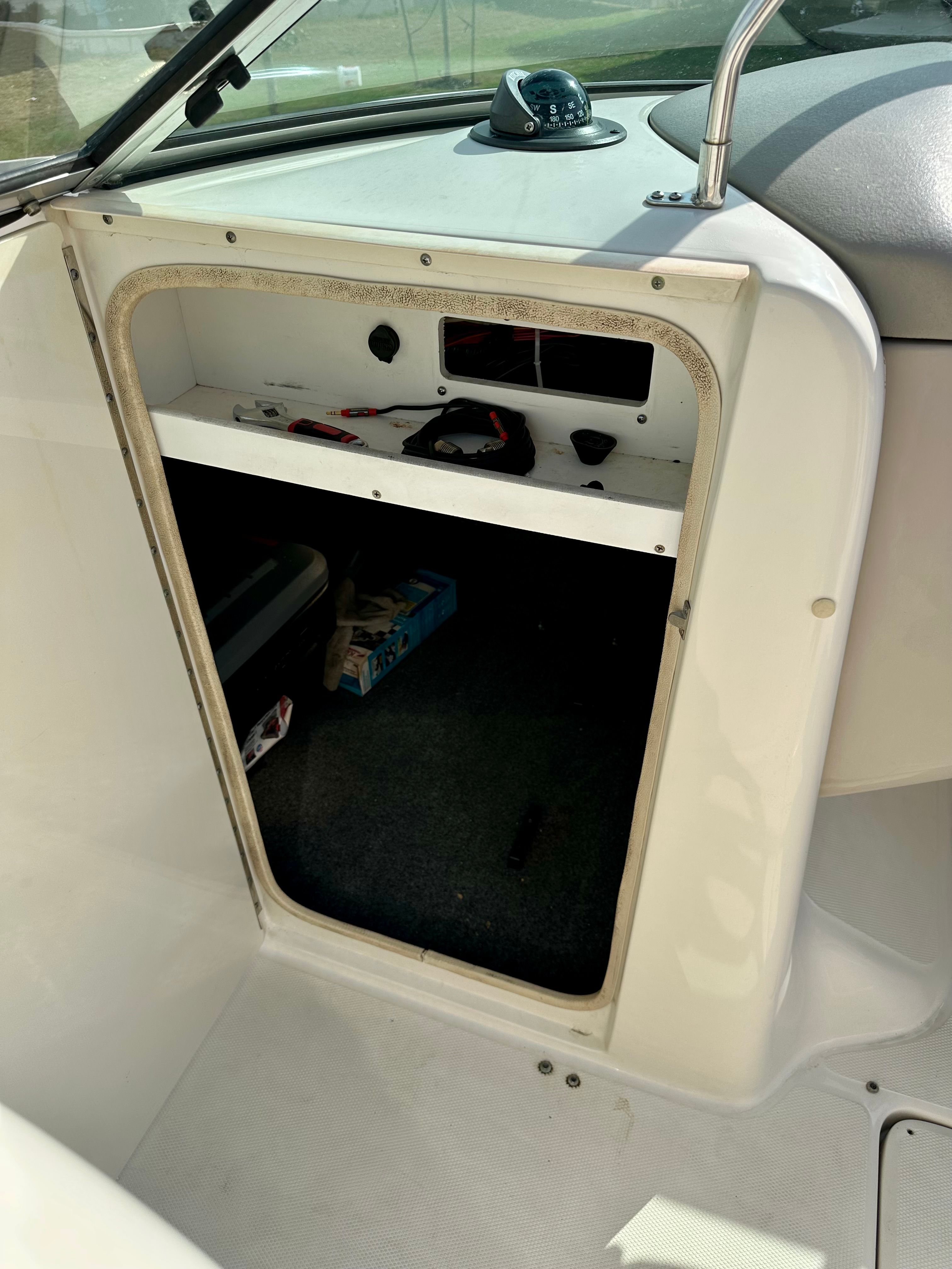 Interior view of a 2006 Sea Ray 240 Sundeck boat, open storage compartment.