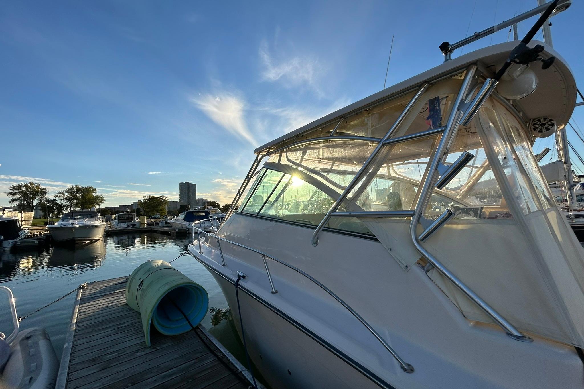 2007 Grady-White Express 360 docked at marina during sunset.