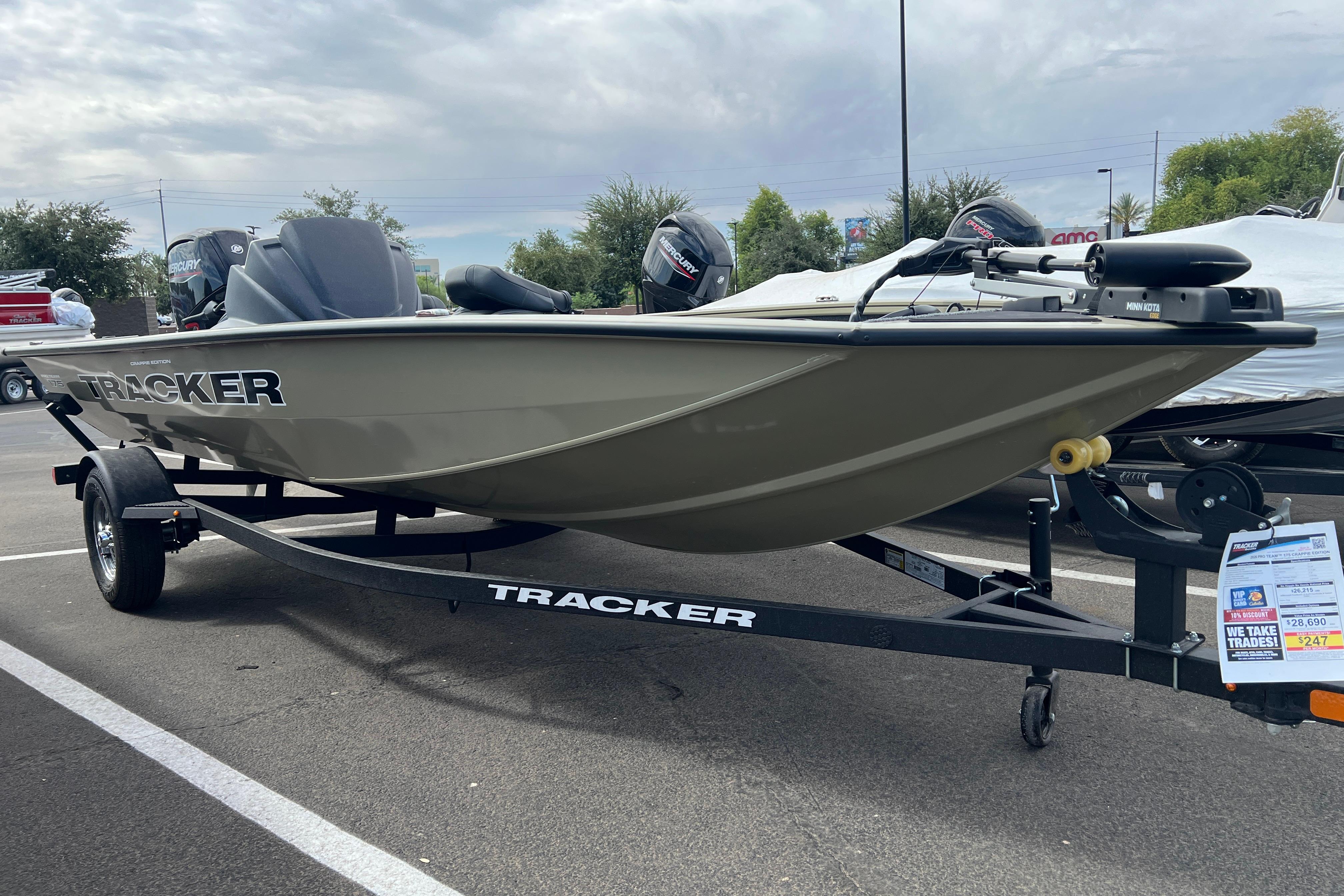 2026 Tracker Pro Team 175 Crappie Edition boat on trailer in parking lot.