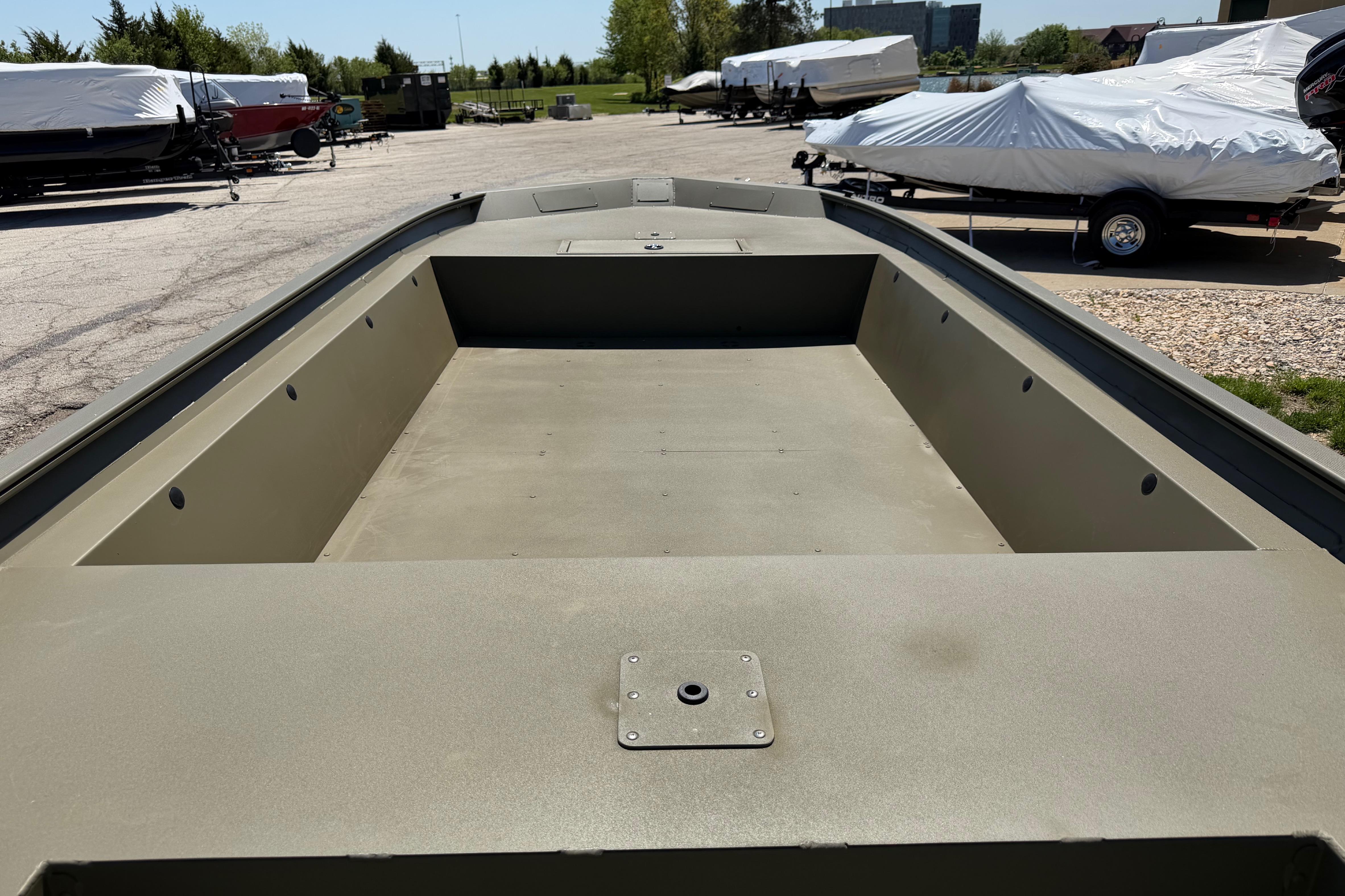 2026 Tracker Grizzly 1860 Utility boat, empty interior view in outdoor setting.