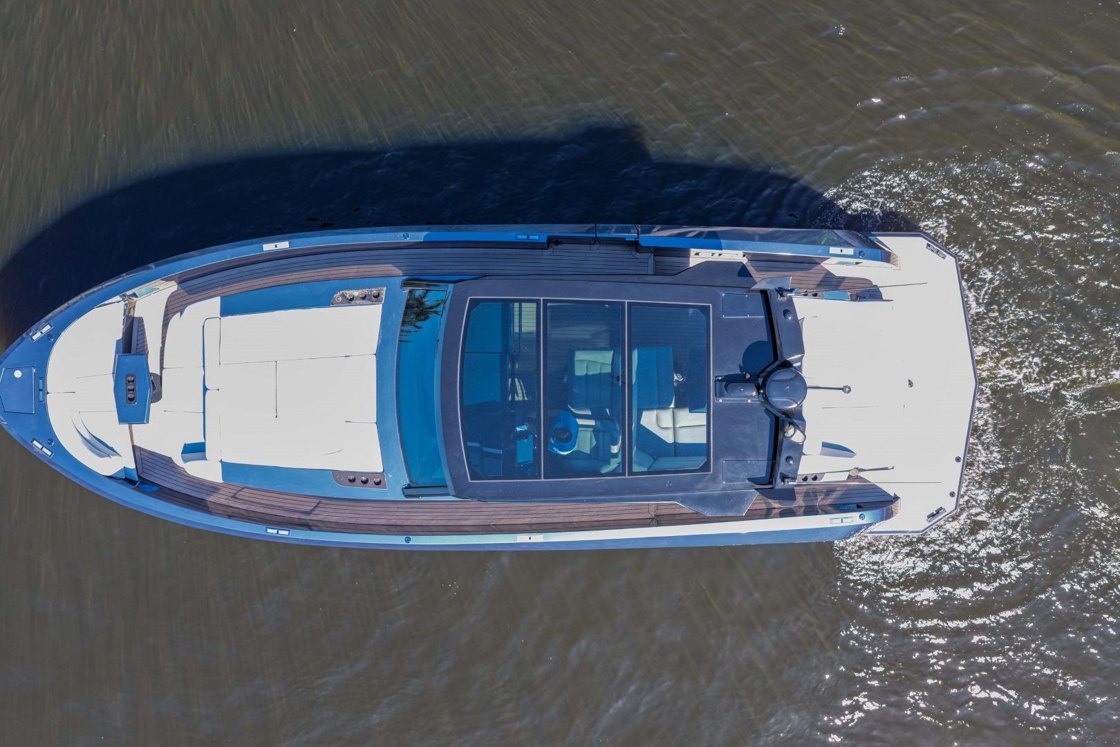 Aerial view of 2022 Vanquish Yachts VQ45 luxury yacht cruising on water.