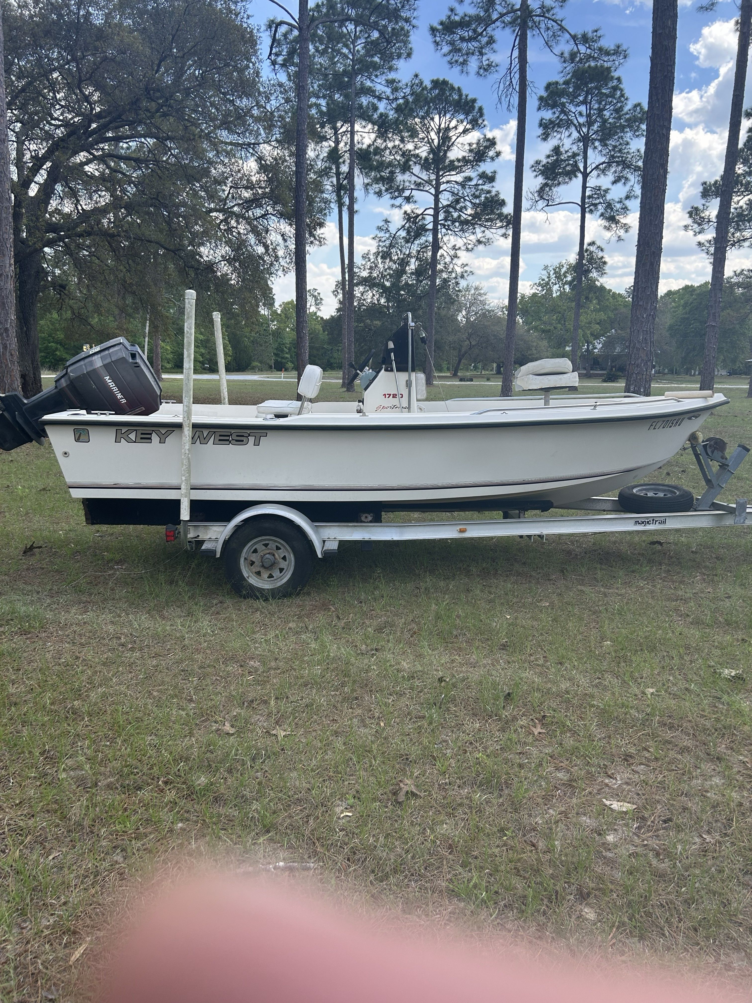 1993 Key West 1720 boat on trailer outdoors.