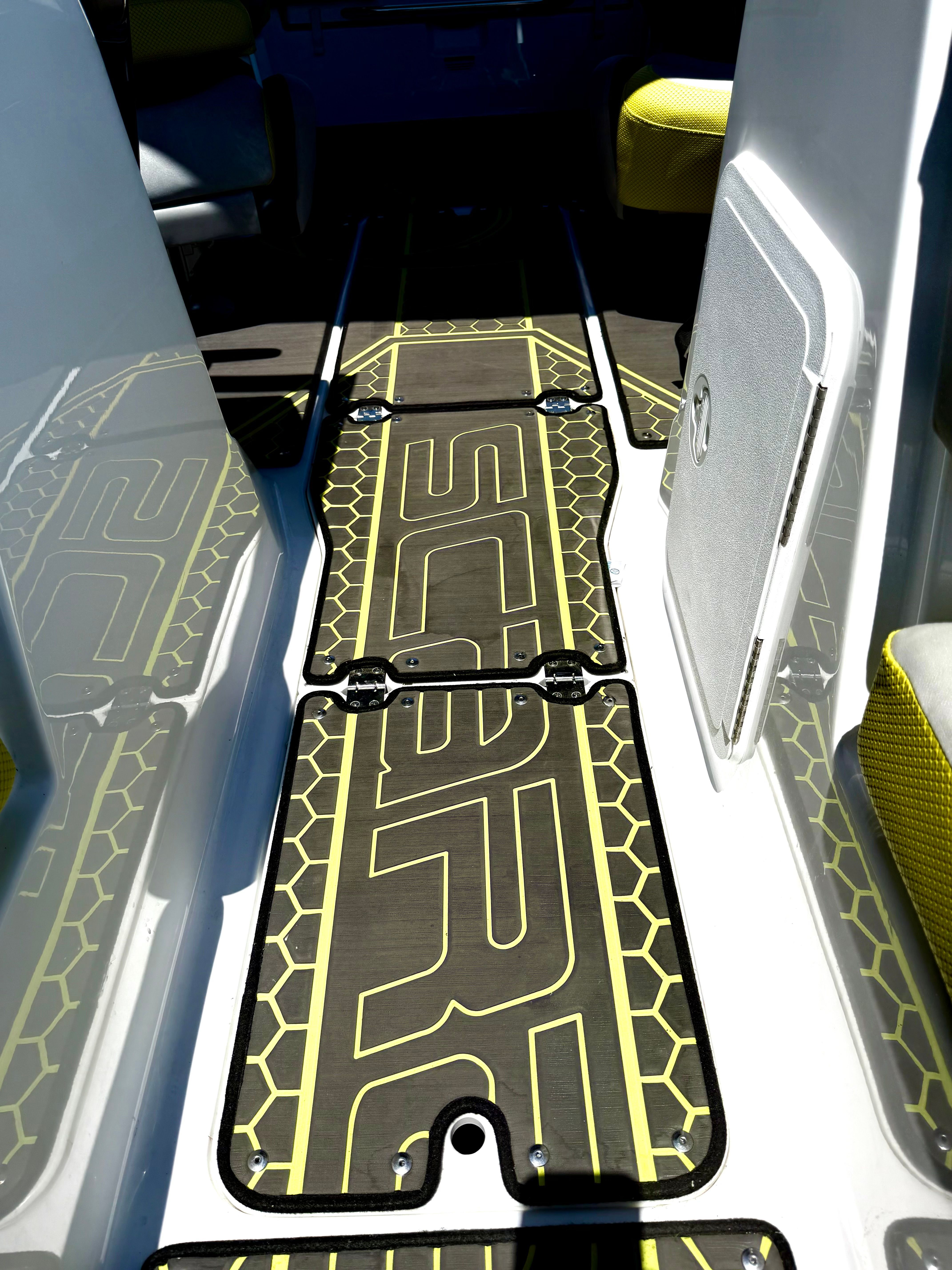 The image shows the floor of a Scarab 215 ID boat with a stylish yellow design.