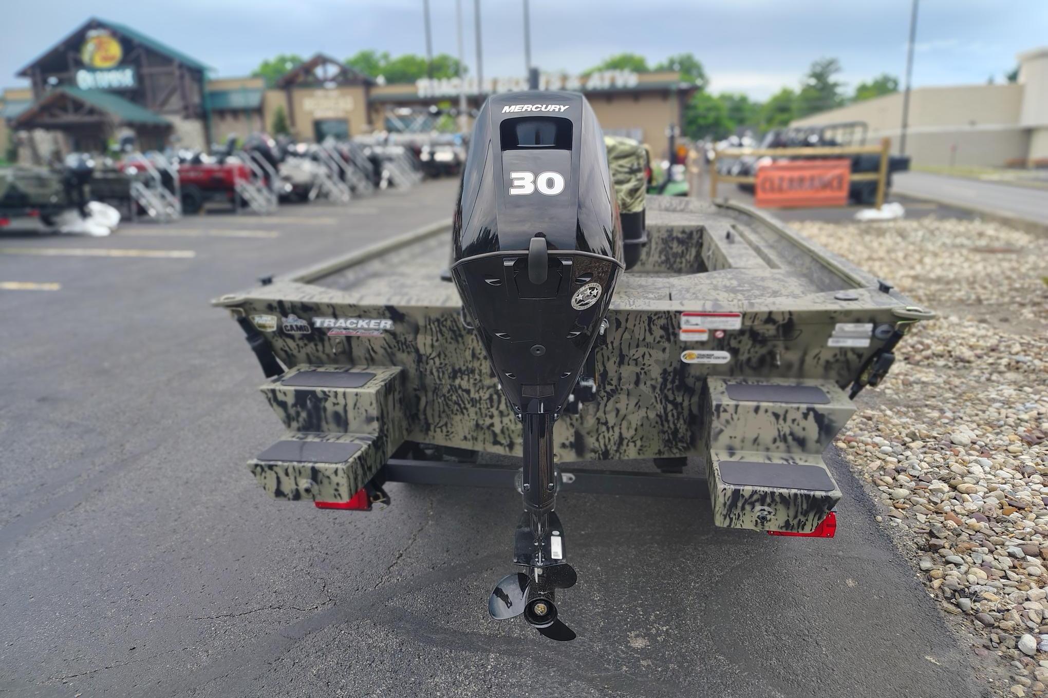 2026 Tracker Grizzly 1654 T Sportsman boat with Mercury 30 engine, parked outdoors.