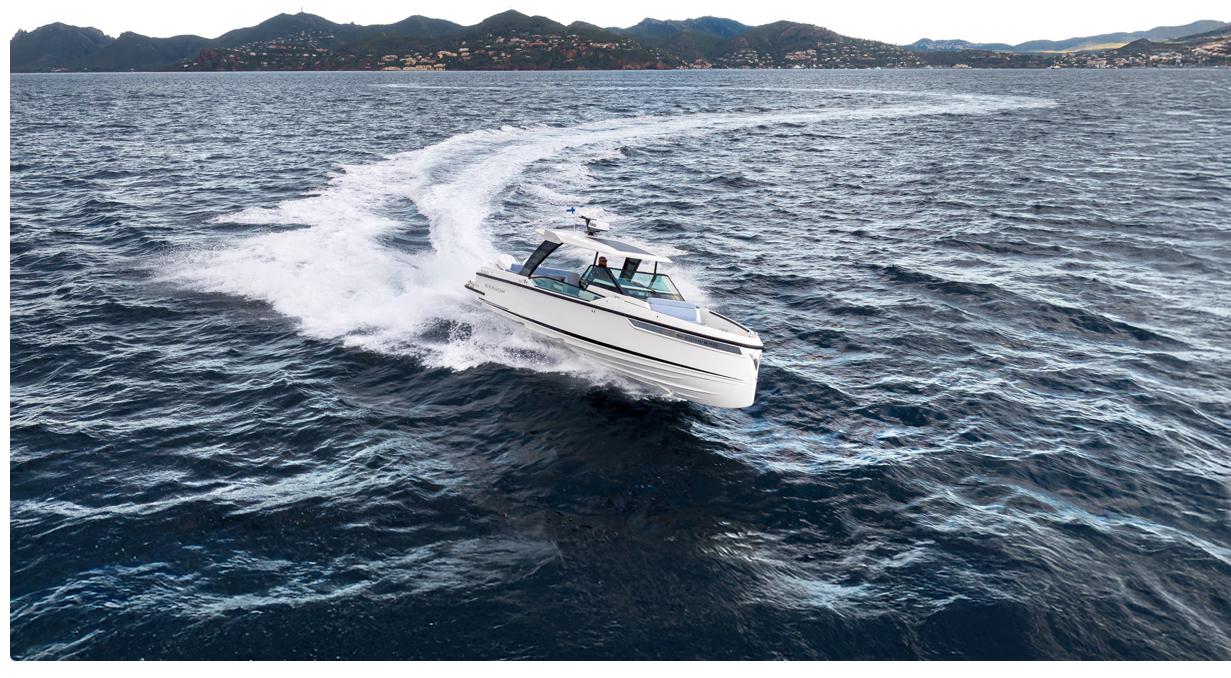 2025 Saxdor 320 GTO cruising on open water with scenic mountain backdrop.