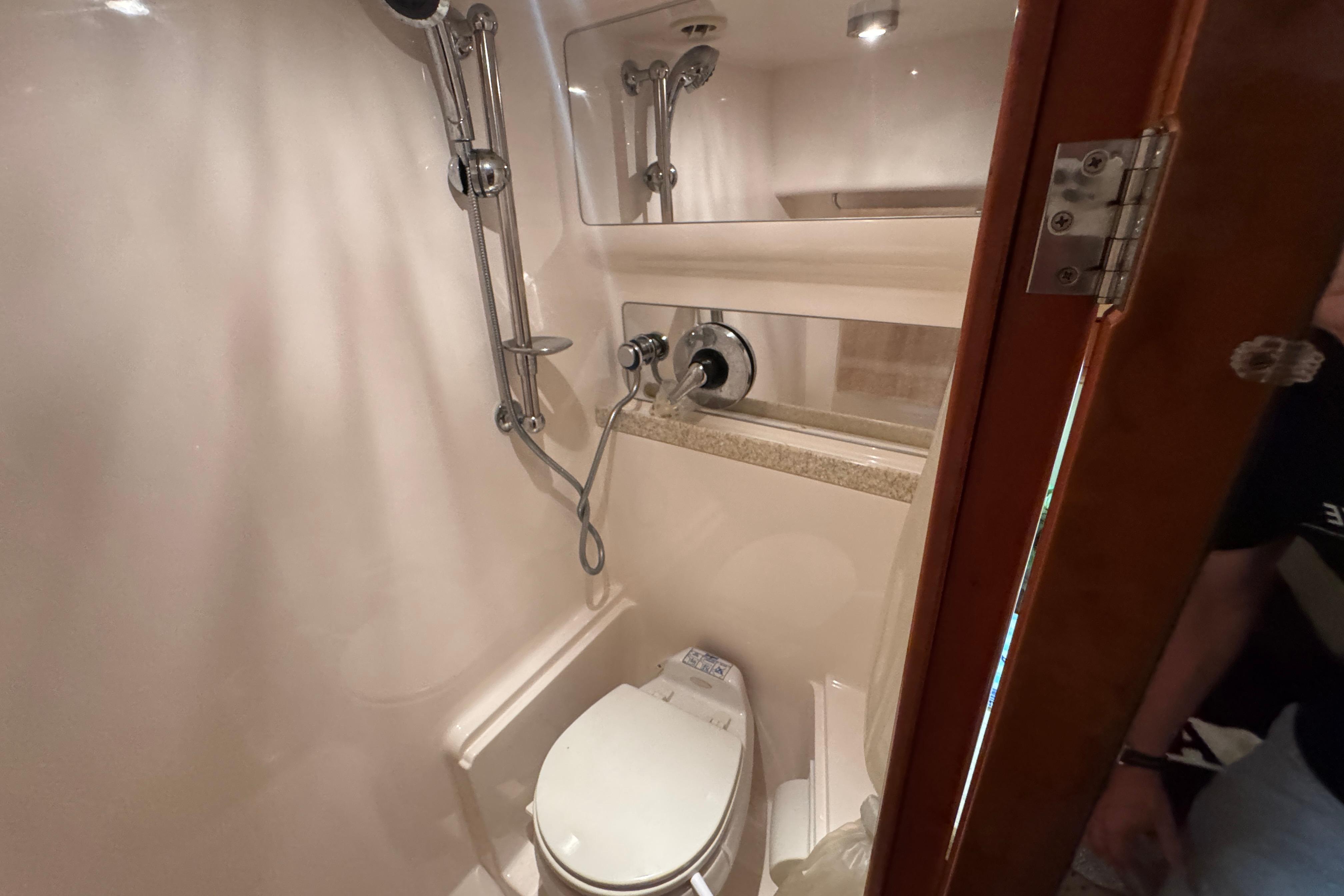 Compact bathroom in 2005 Regal Commodore 4260 yacht with shower and toilet.