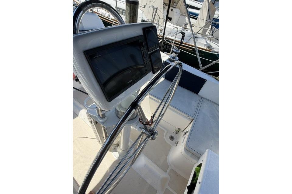 Steering wheel and navigation system on 2002 Saga 43 sailboat deck.
