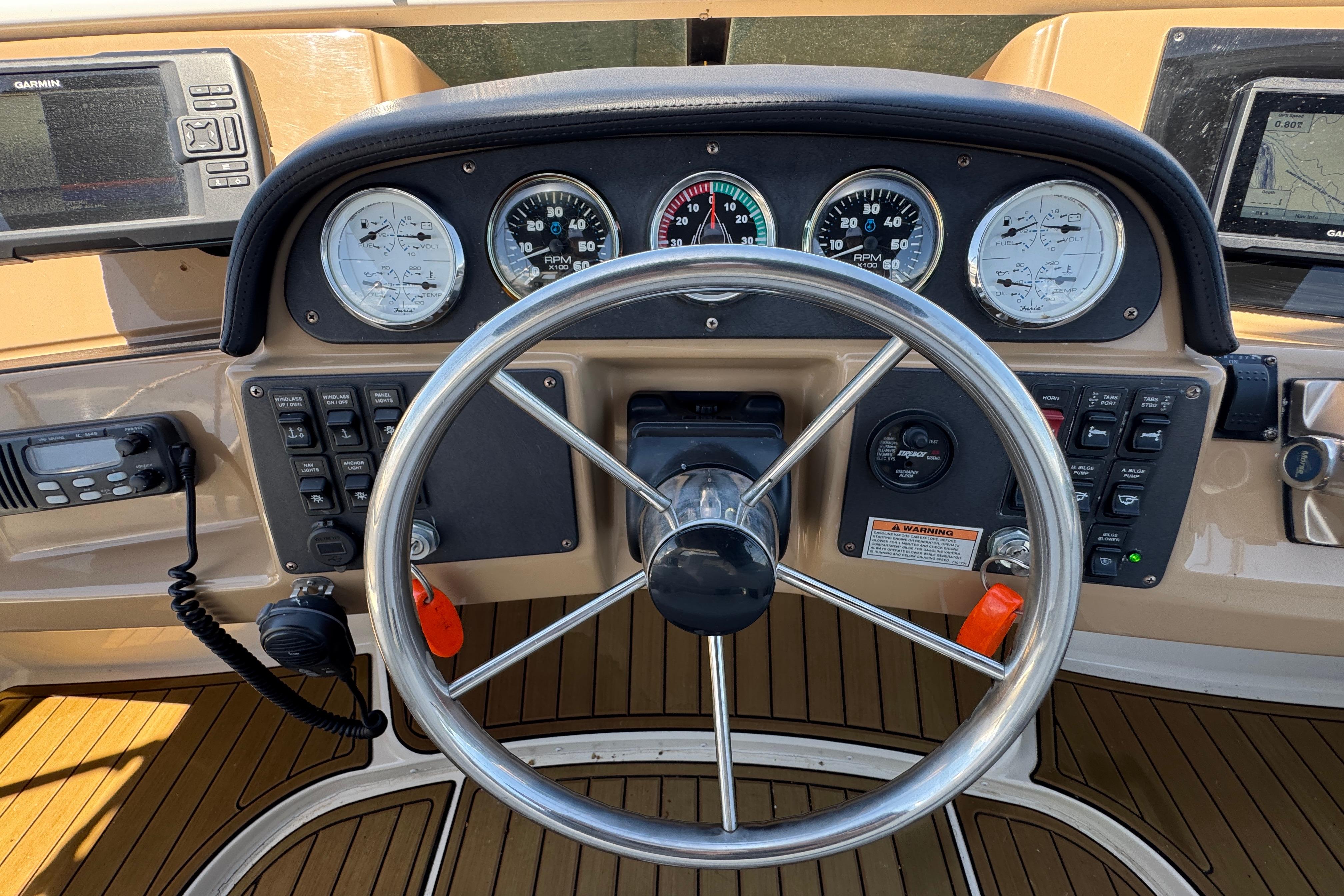 Steering console of a 2002 Carver 396 Motor Yacht with gauges and navigation equipment.