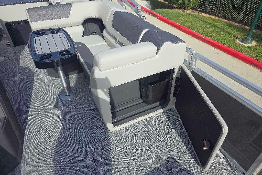 2026 Sun Tracker Fishin' Barge 20 DLX interior with seating and table.