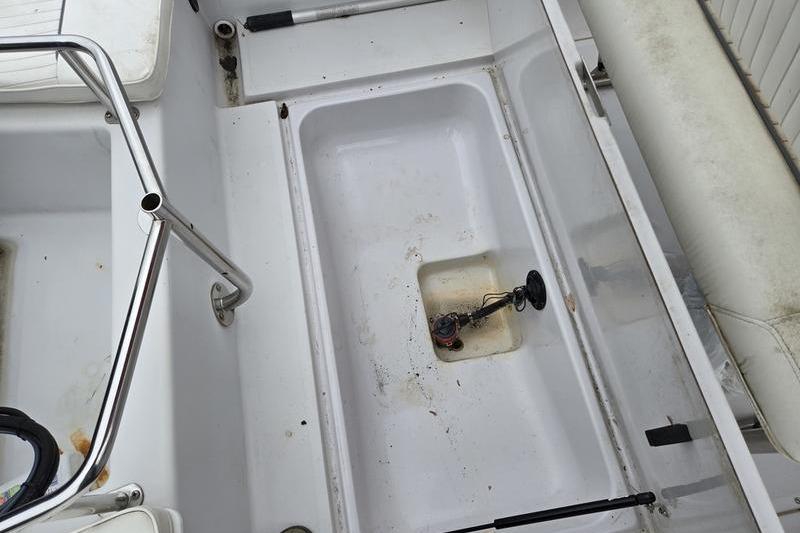 1996 Boston Whaler Outrage 17 interior showing seating and storage compartments.