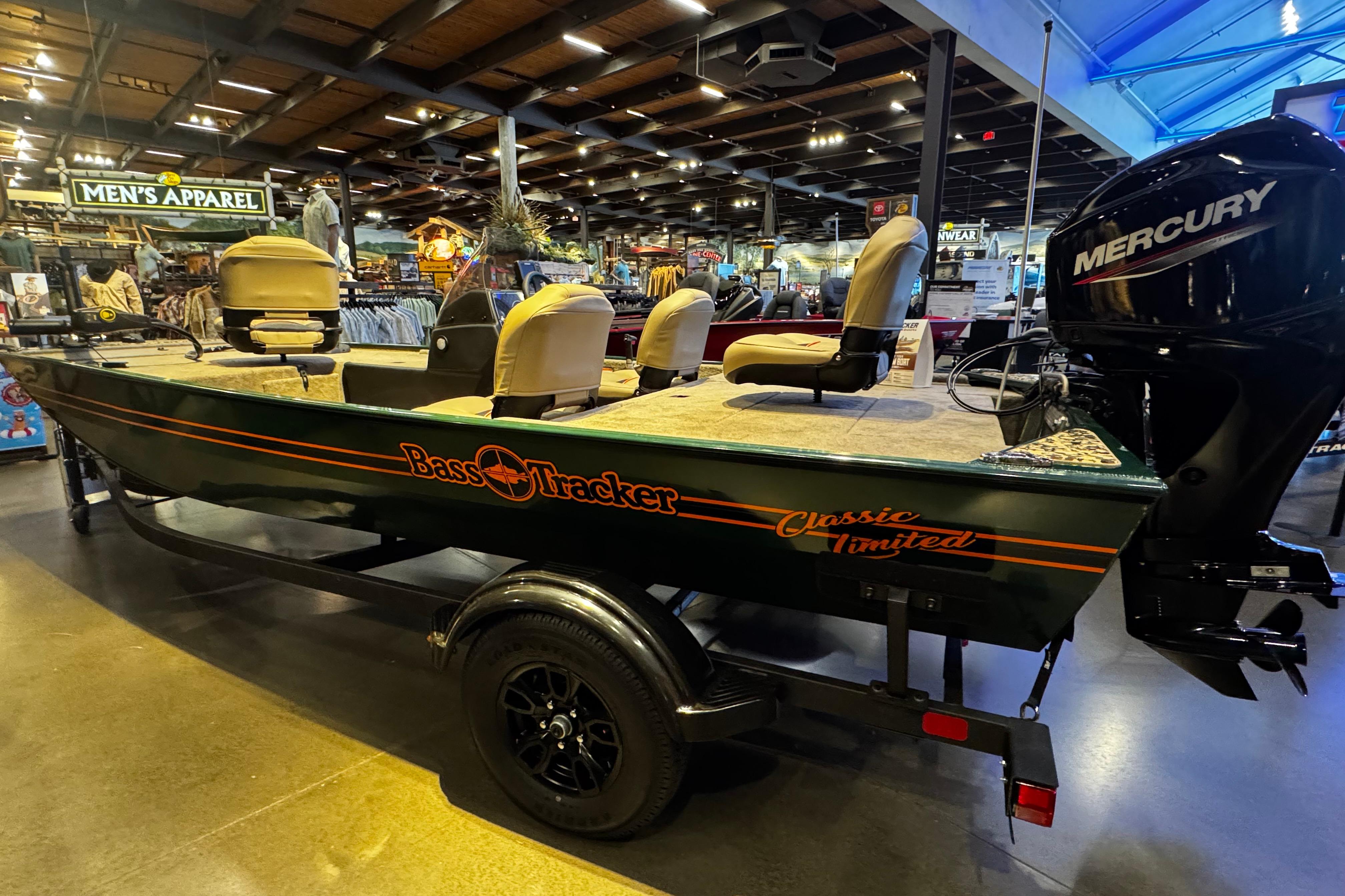2026 Tracker Bass Tracker Classic Limited boat displayed indoors with Mercury engine.
