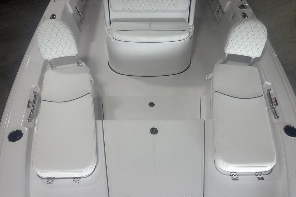 2026 Sportsman Masters 227 boat interior with white cushioned seating and sleek design.