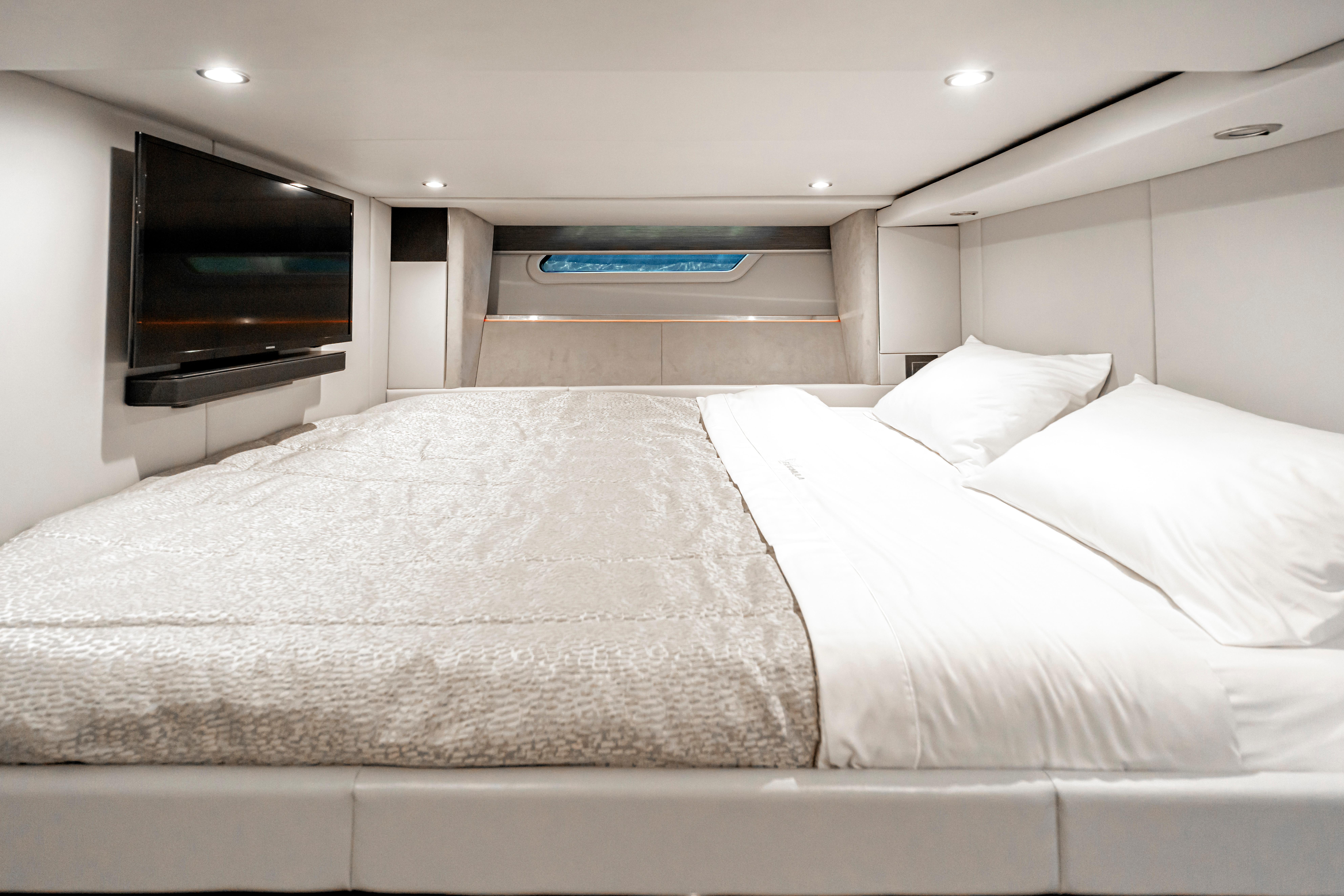 Luxurious cabin interior of 2022 Formula 500 Super Sport Crossover with bed and TV.