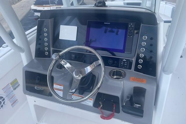 2024 Robalo R230 Center Console boat dashboard with steering wheel and navigation system.