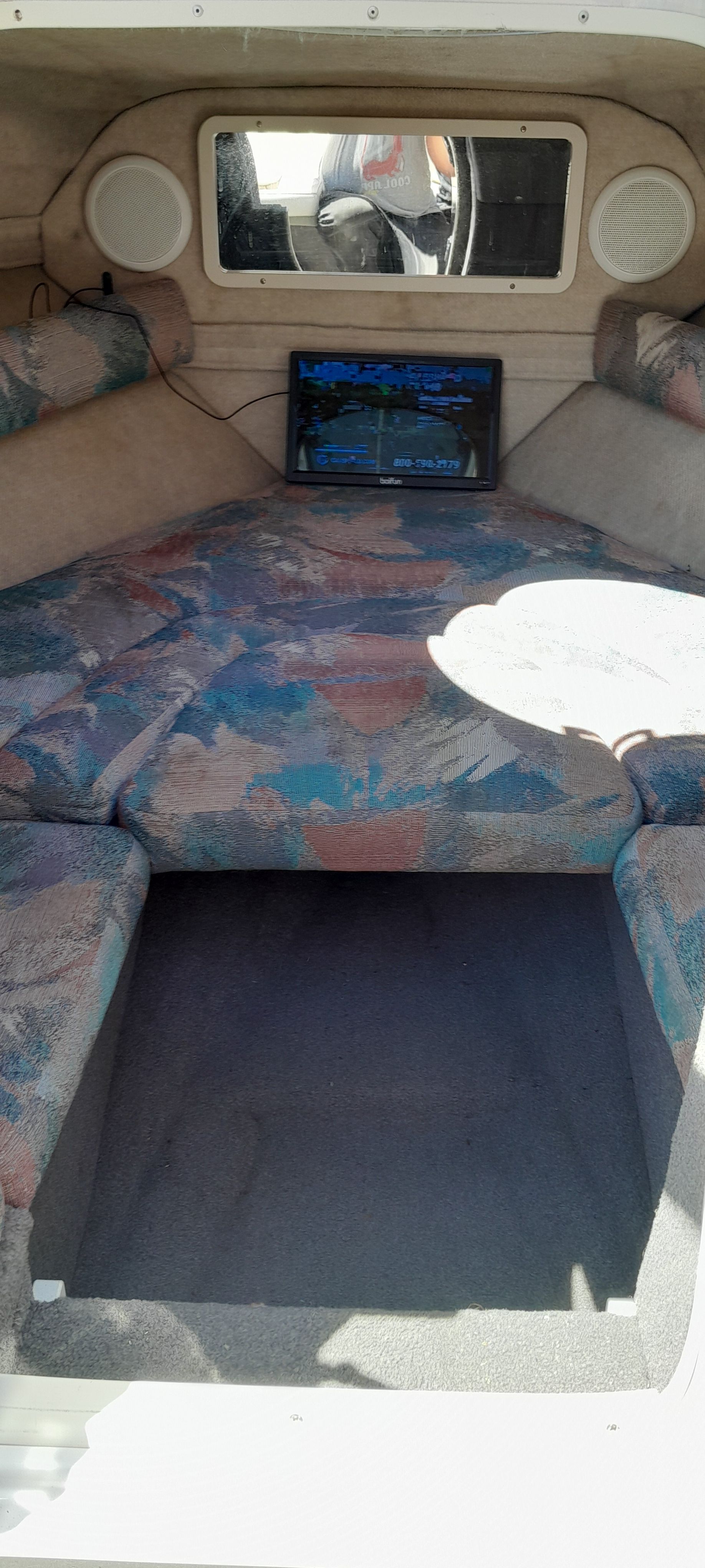 Interior of a 1995 Four Winns 205 Sundowner boat with upholstery.