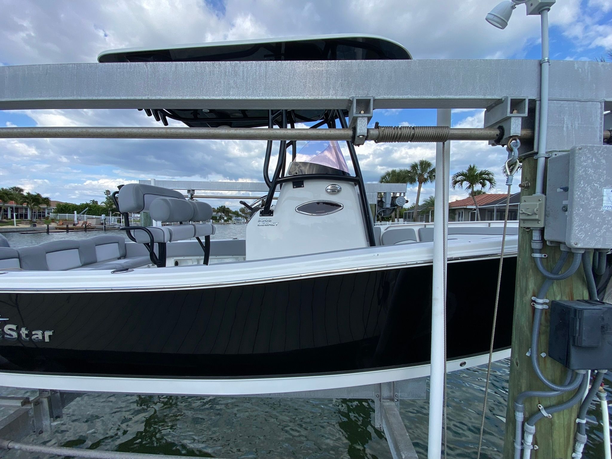 2021 NauticStar Legacy boat on a lift by the water.