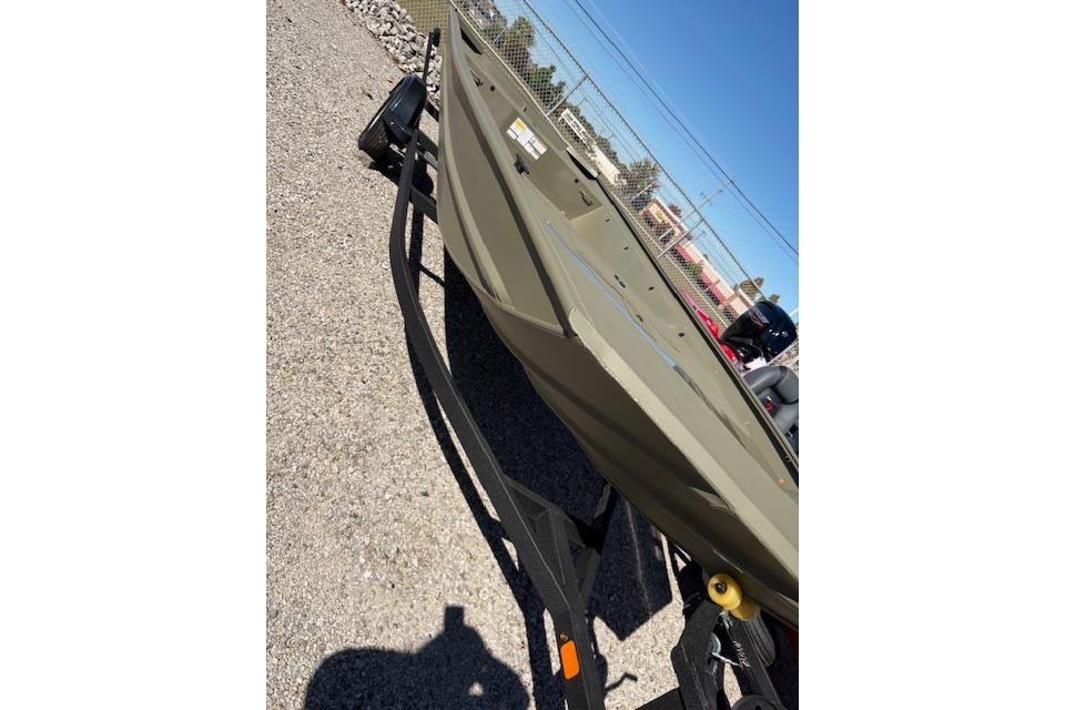 2026 Tracker Grizzly 1860 Utility boat on trailer, parked outdoors.