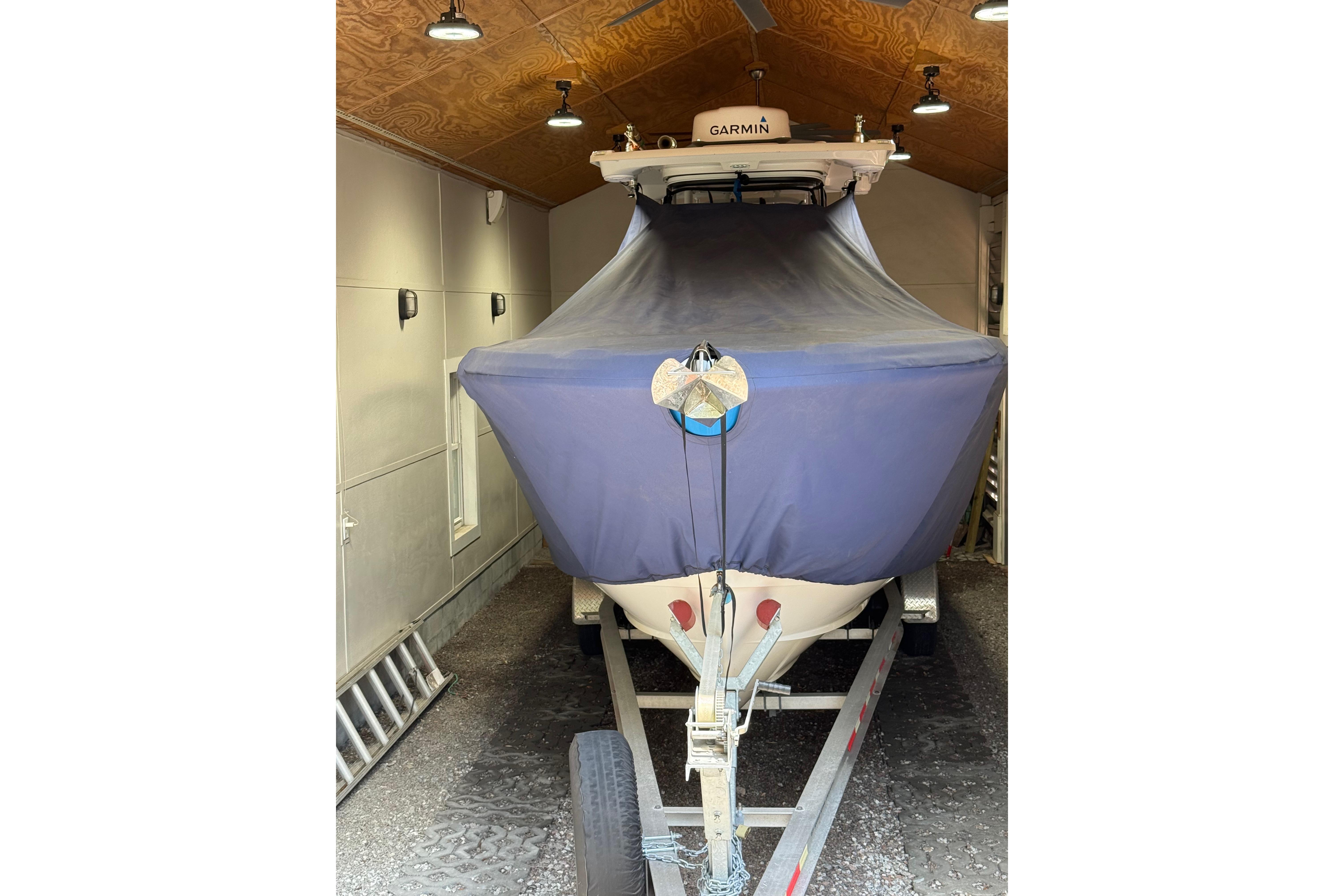 2022 Edgewater 280CC boat covered and stored in a garage.