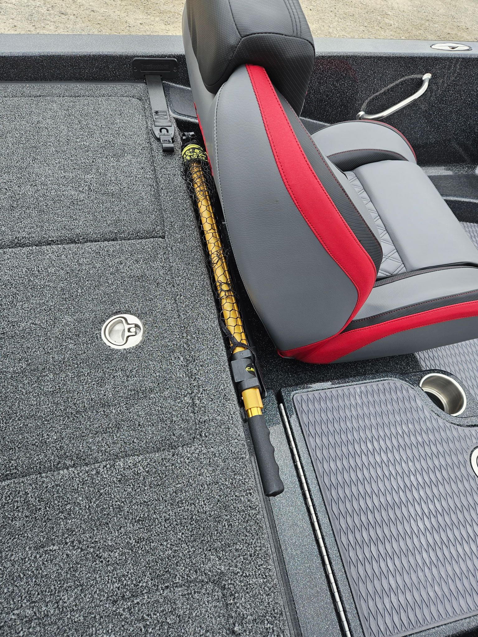 Interior of Caymas CX 21 PRO boat, seat and fishing gear.