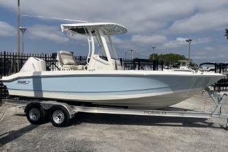 2024 Boston Whaler 220 Dauntless boat on trailer, parked outdoors.