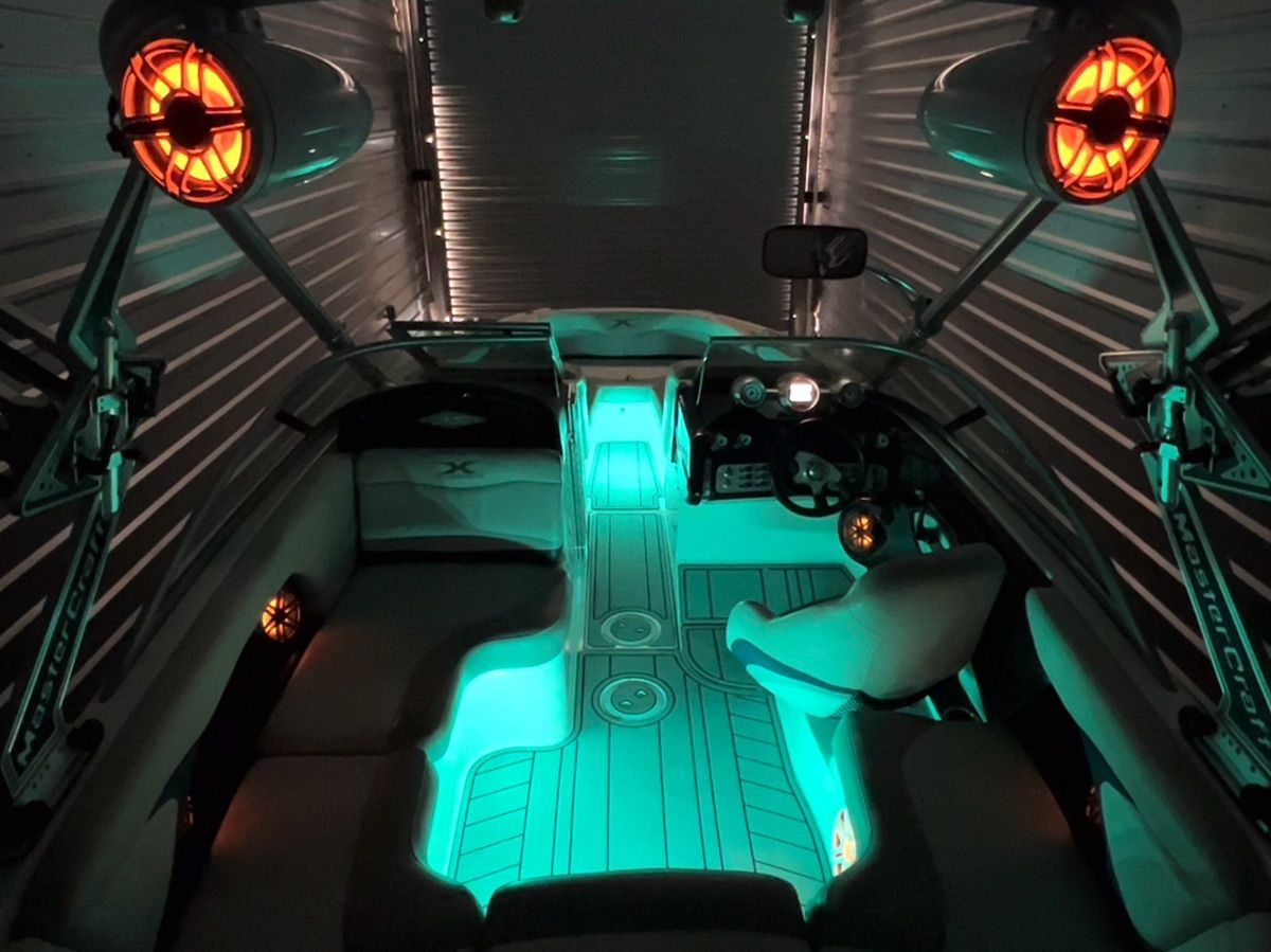 2008 MasterCraft XStar with stylish interior lighting and modern speakers in a garage.