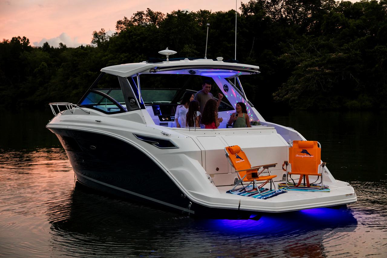 Manufacturer Provided Image: 2022 Sea Ray Sundancer 320 yacht with blue underwater lights at sunset.