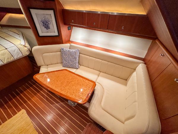 Luxurious interior of 2006 Tiara Yachts 3200 Open with elegant seating and wooden table.