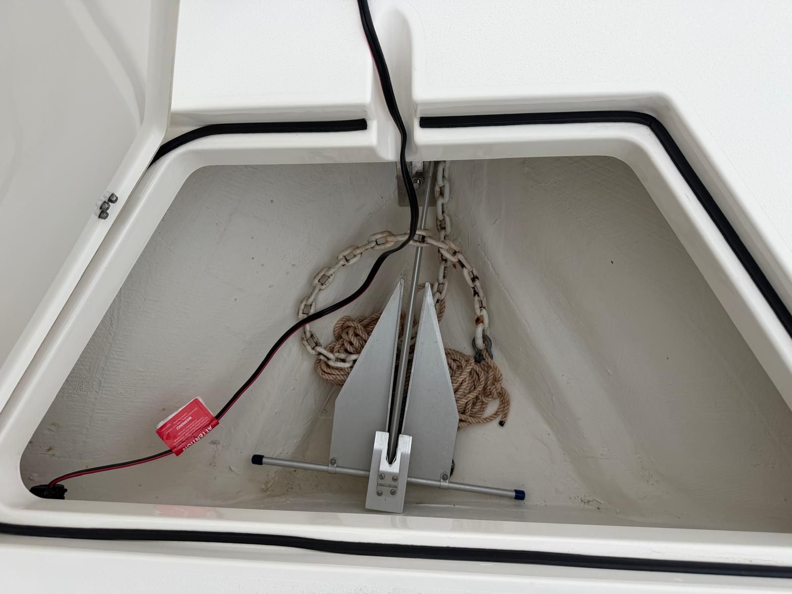 An anchor locker with chain and rope on a boat.