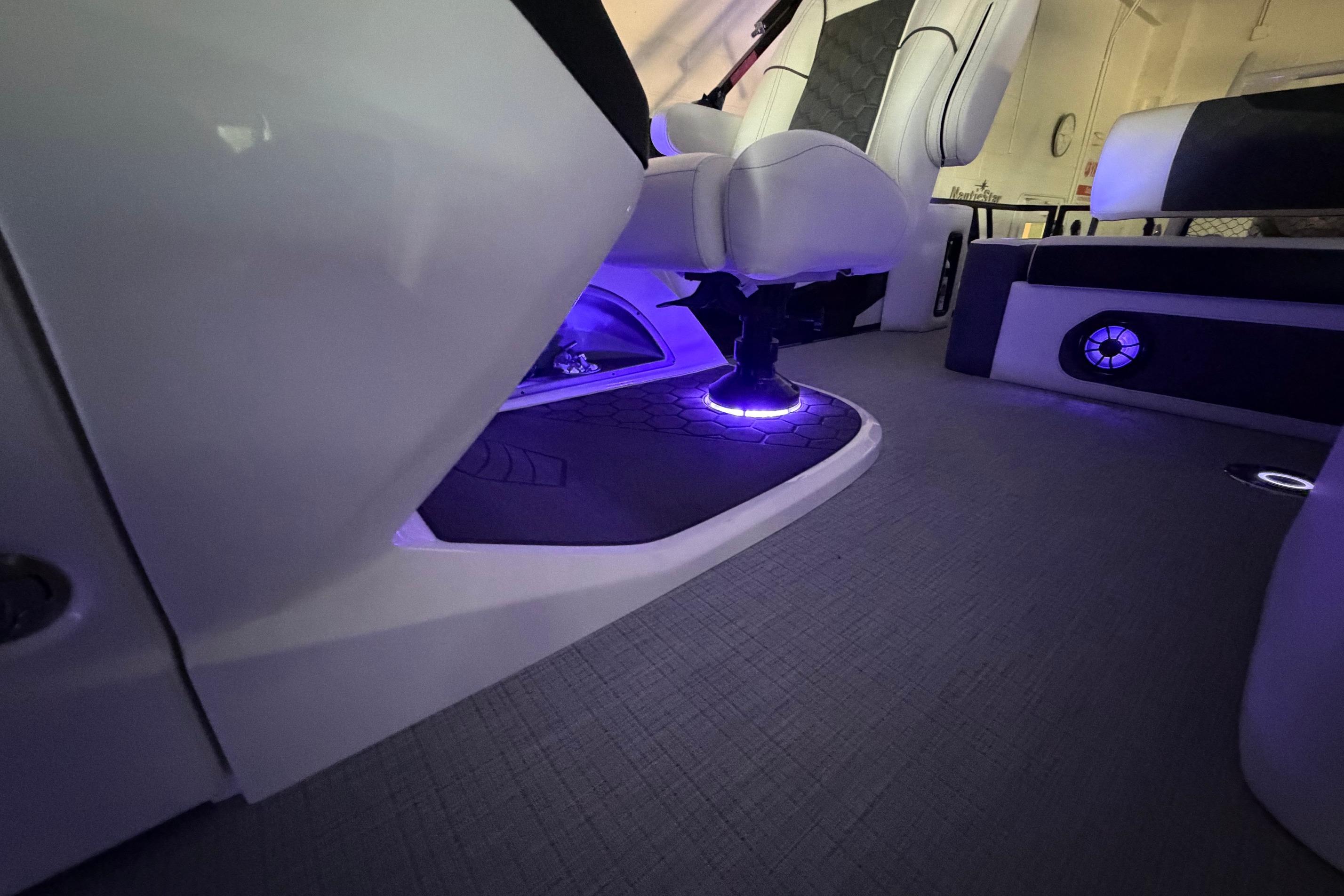Luxurious interior of 2026 South Bay 525SB2 boat with ambient purple lighting.