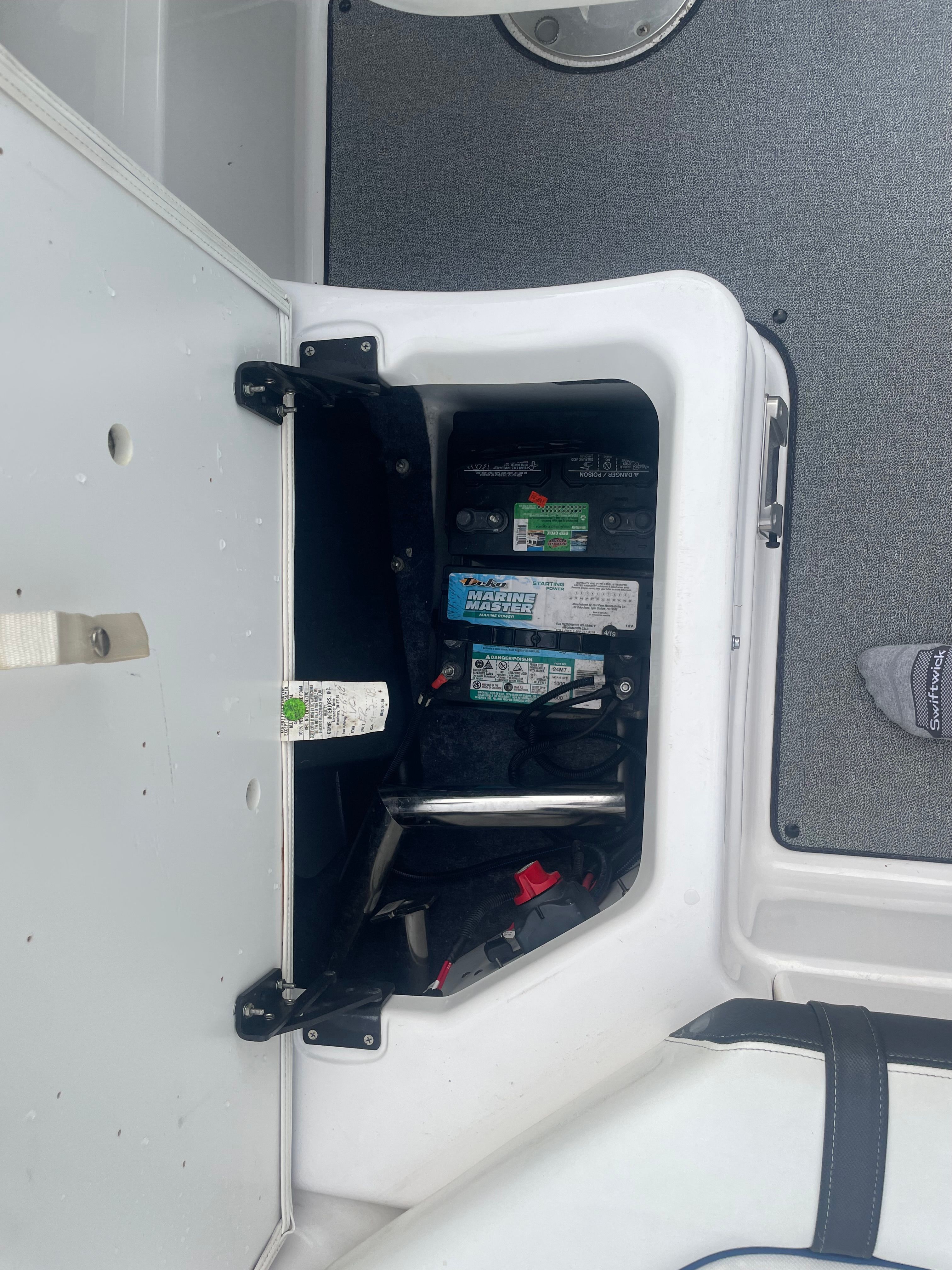 Battery compartment of a 2019 Yamaha SX210 boat with visible cables and components.