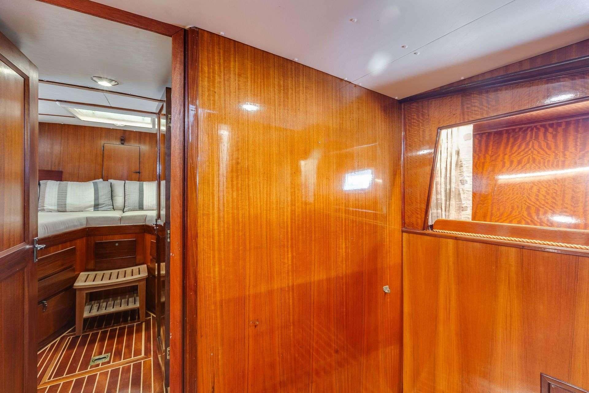 1973 Hatteras 58 Tricabin yacht interior with polished wood and cozy cabin.