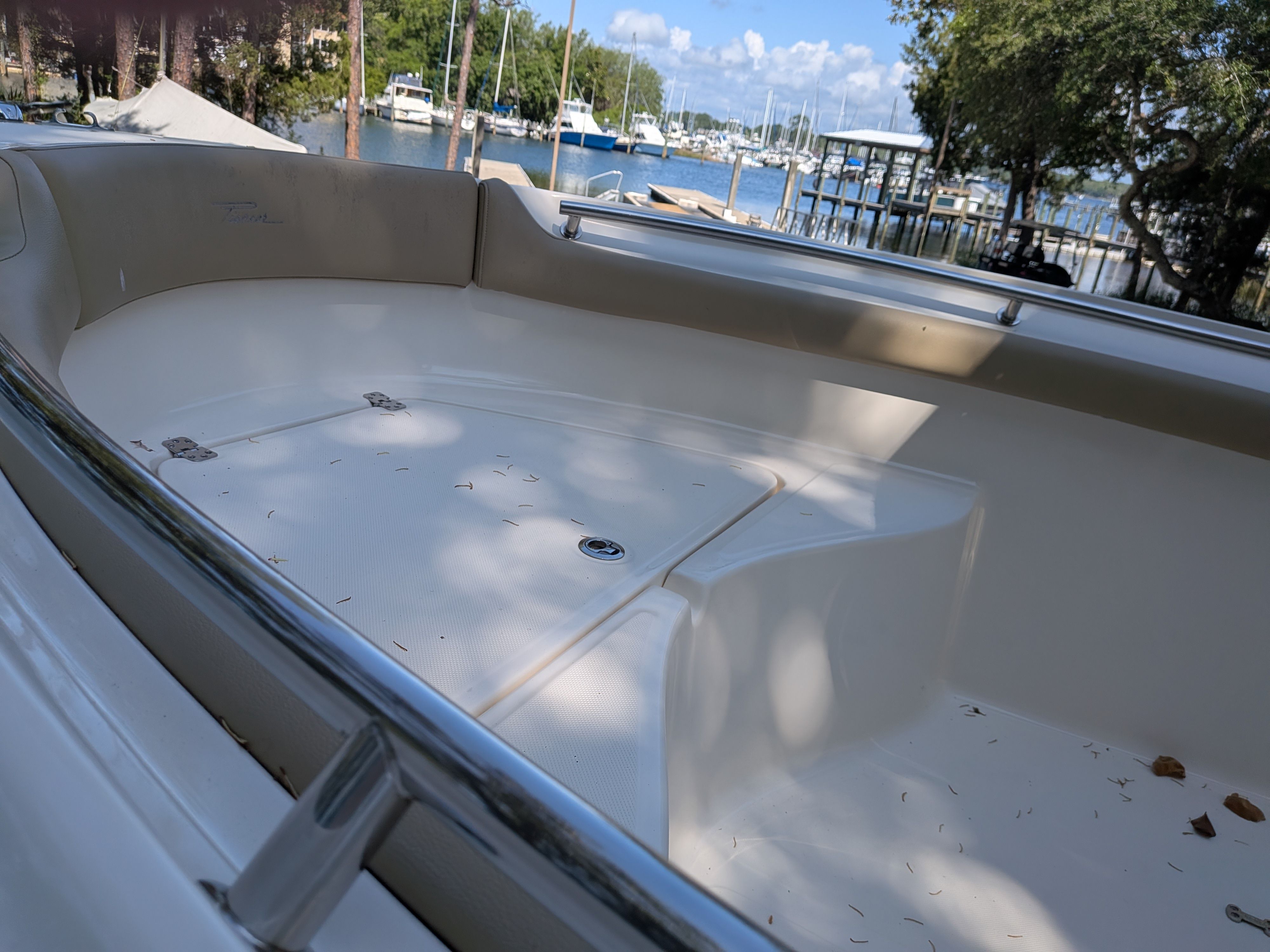 Interior view of a 2020 Pioneer 202 Sportfish boat by the water.