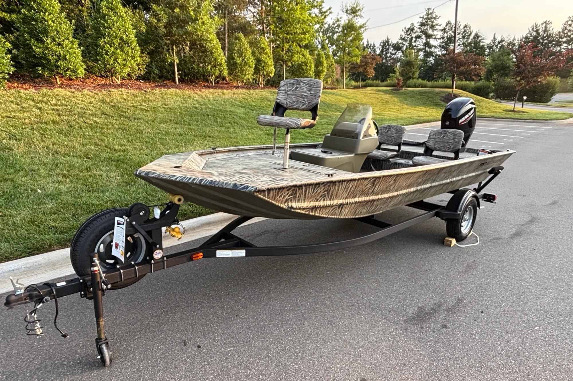 2026 Tracker Grizzly 1754 SC boat on trailer, parked in a scenic outdoor setting.