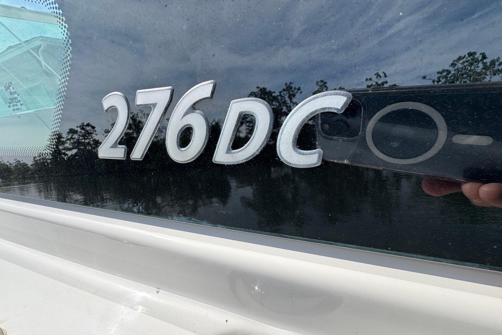 2022 Sailfish 276 DC boat model emblem on reflective surface.