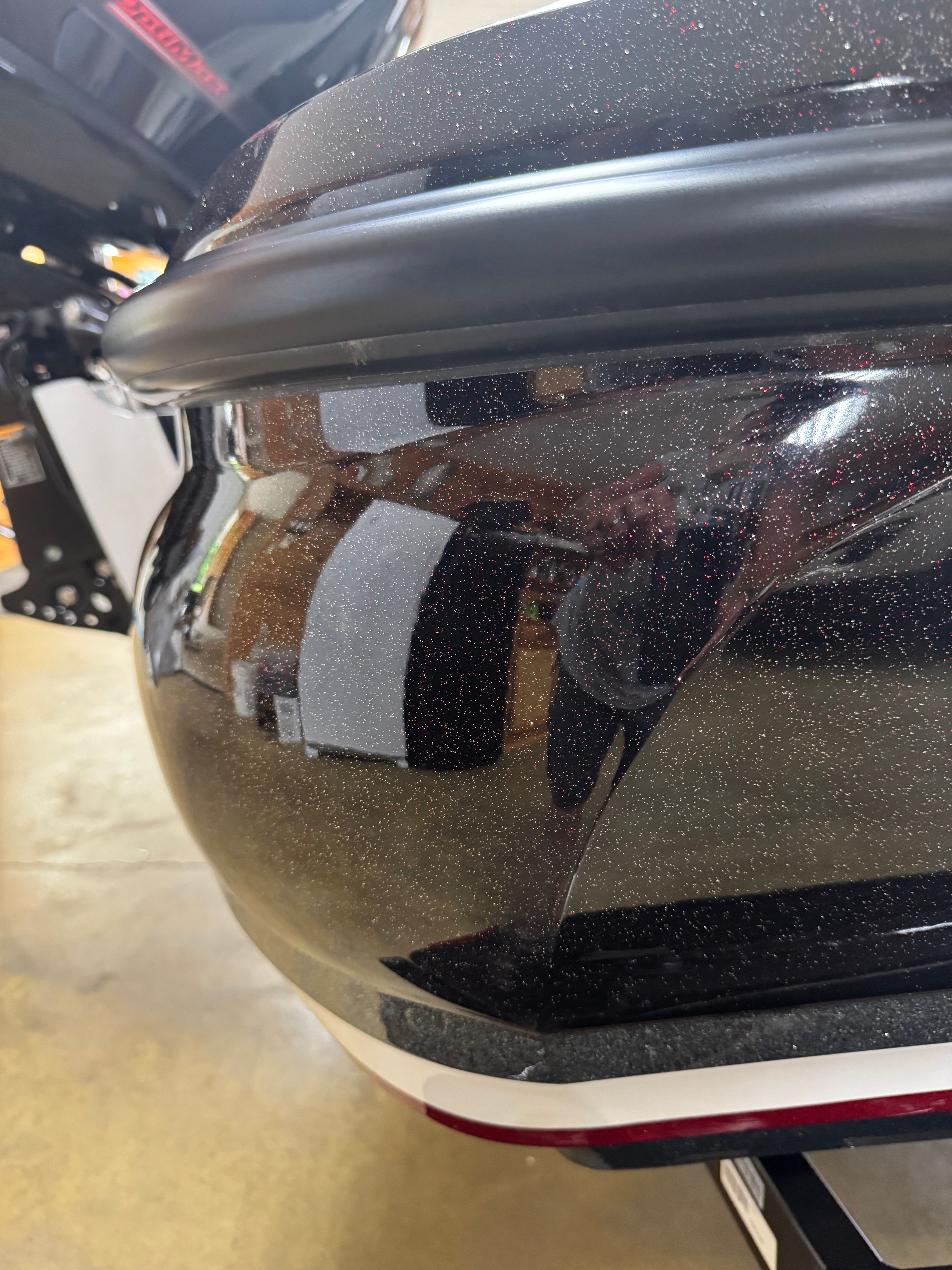 Close-up of a shiny boat hull in a workshop.
