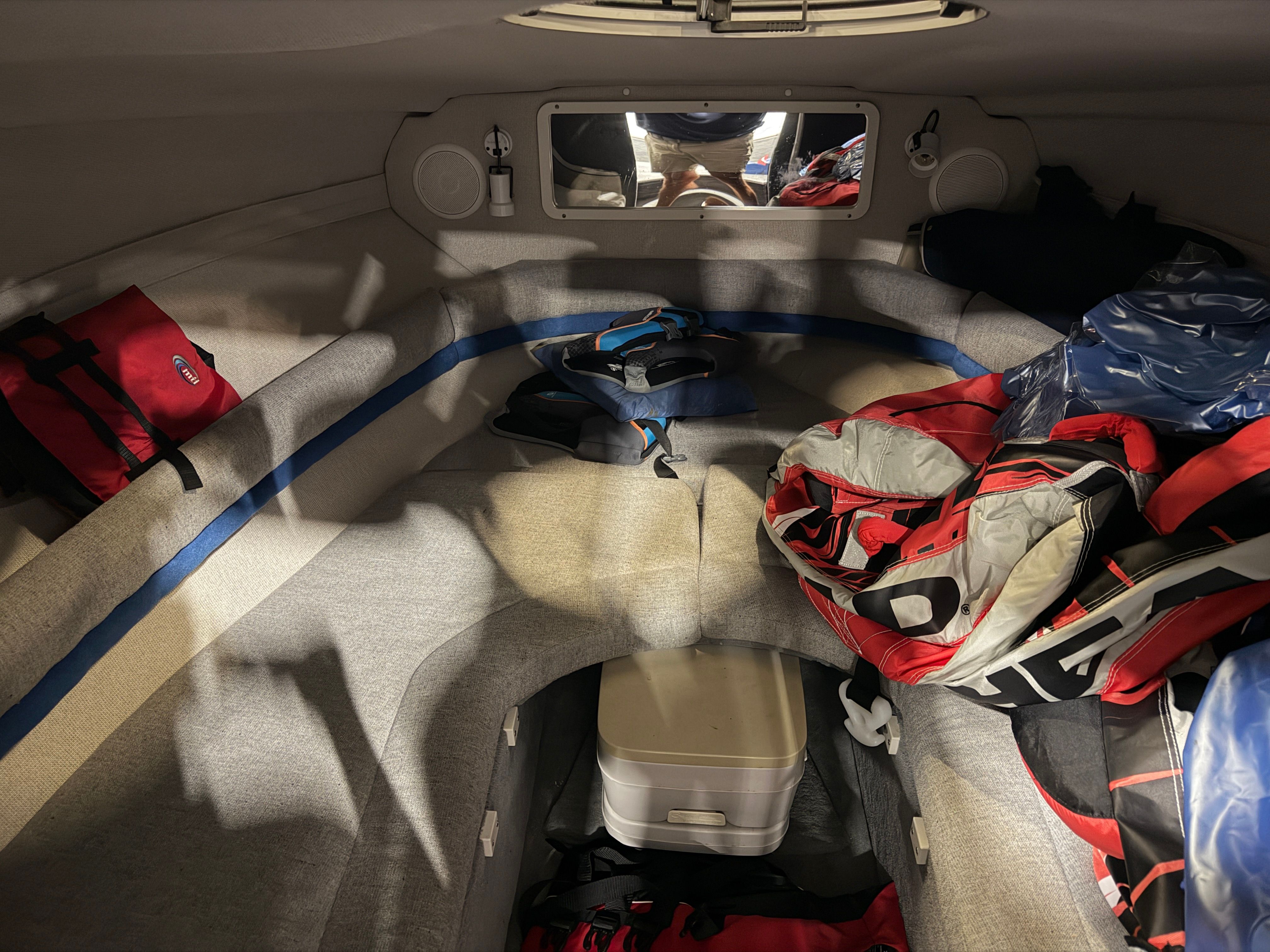 Interior of a 1992 Four Winns 225 Sundowner with seating and storage space.