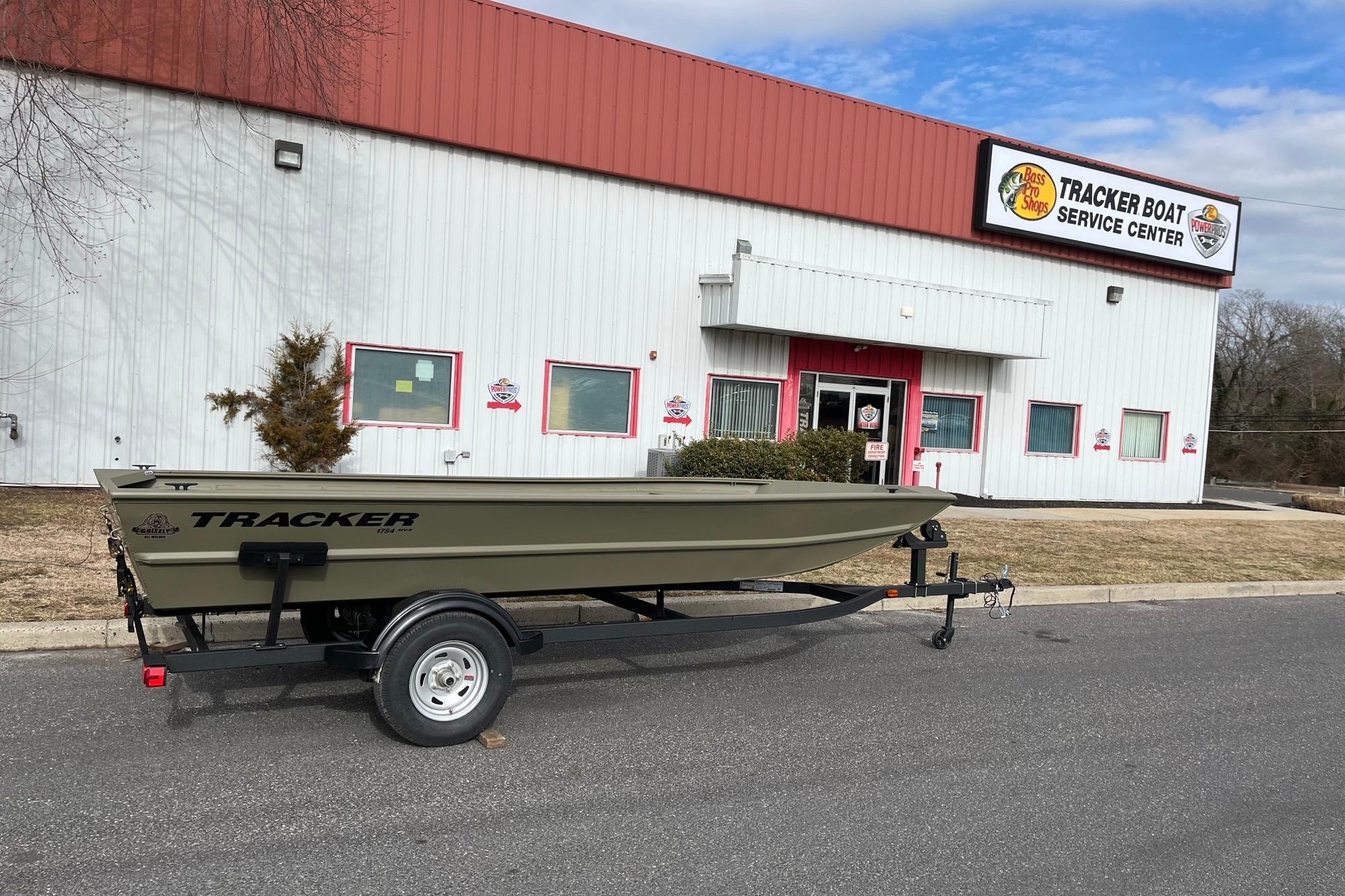 2026 Tracker Grizzly 1754 Utility boat on trailer outside service center.