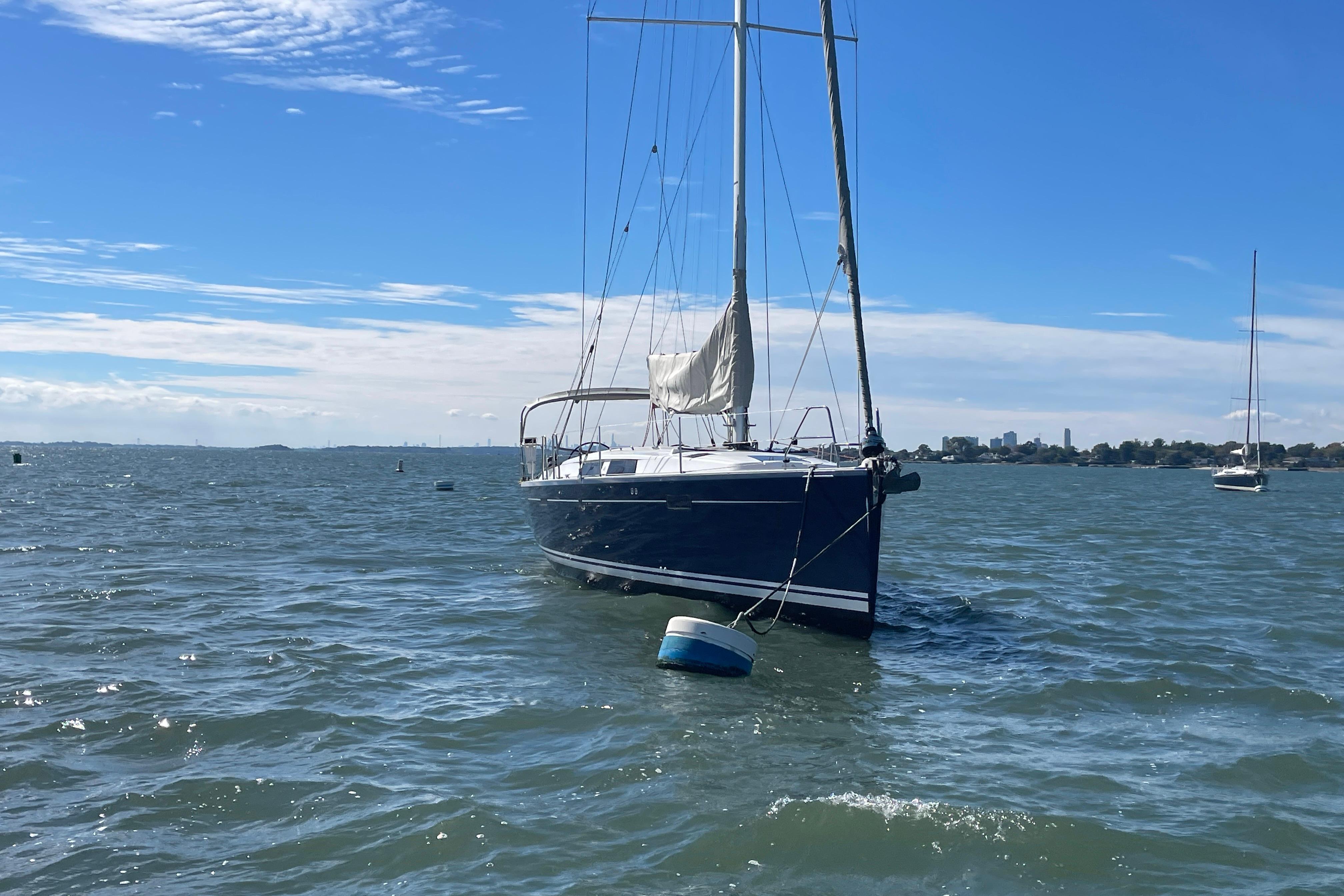 Sailboat Hanse 415 (2014) anchored on a sunny day with clear blue skies.